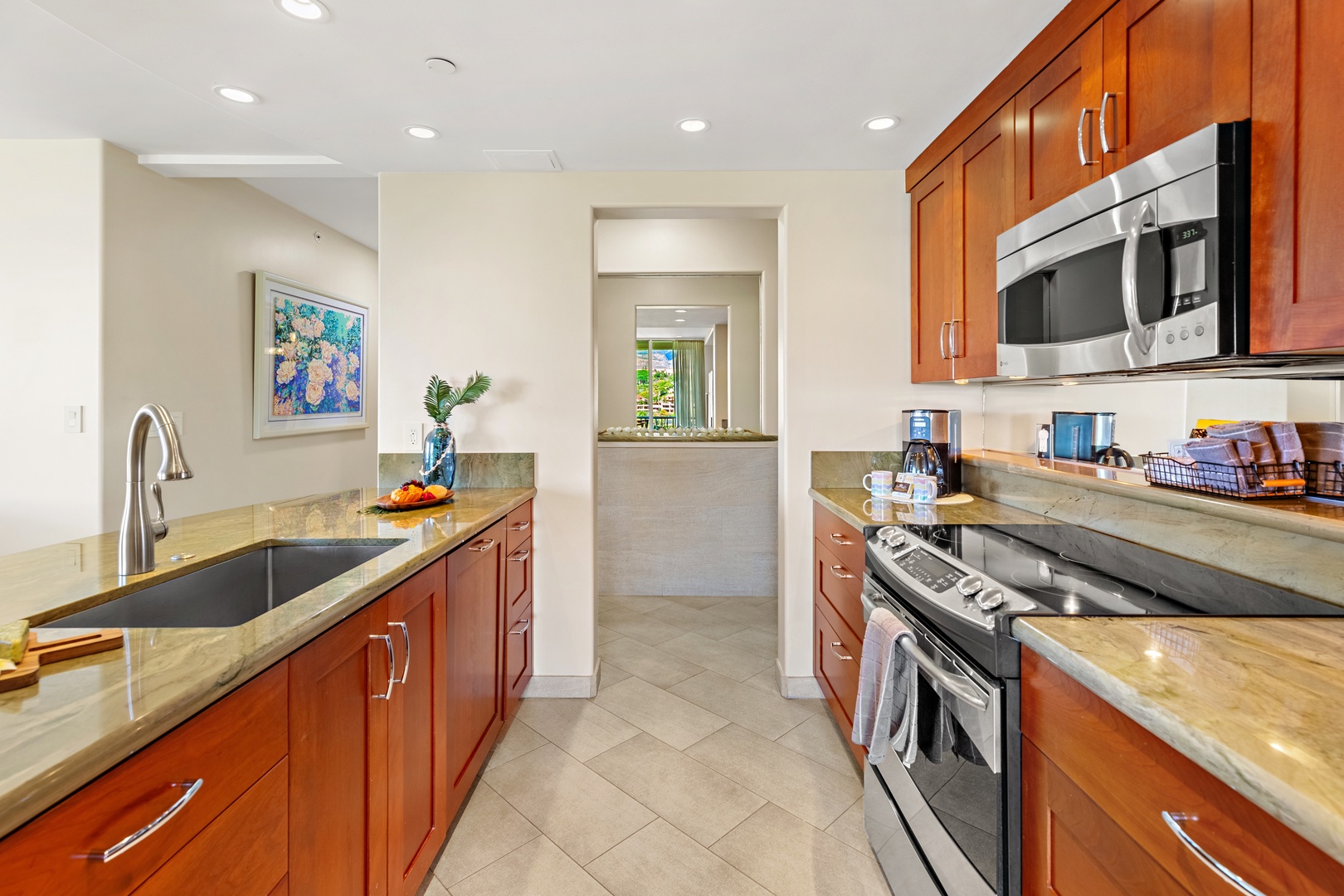 Your gourmet kitchen is fully equipped with rich wood cabinetry, sleek stainless steel appliances, and elegant stone countertops—perfect for preparing anything from quick snacks to memorable meals.