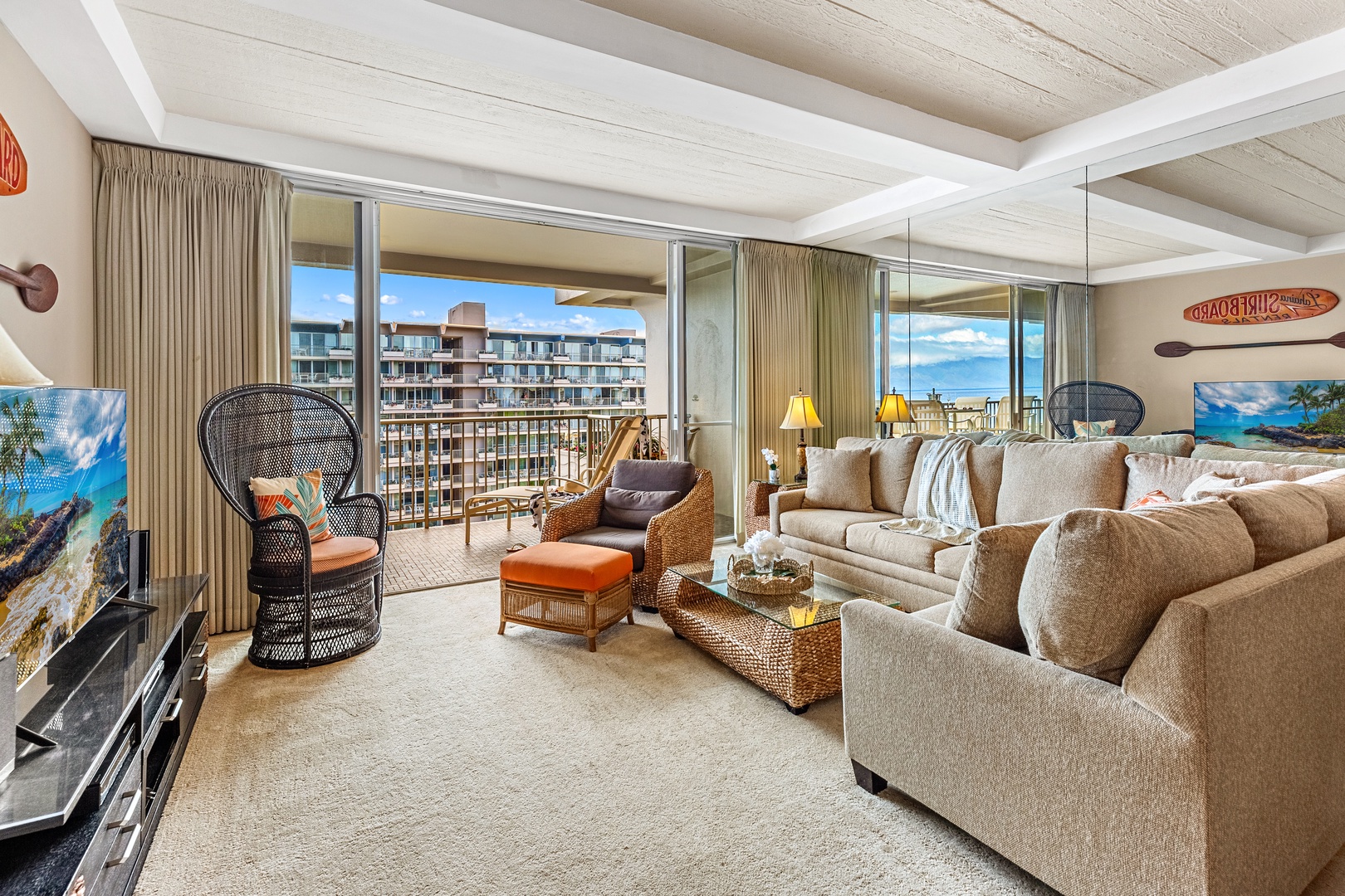 Sink into plush sofas and savor panoramic ocean views through floor-to-ceiling windows in your bright, coastal-inspired living space.