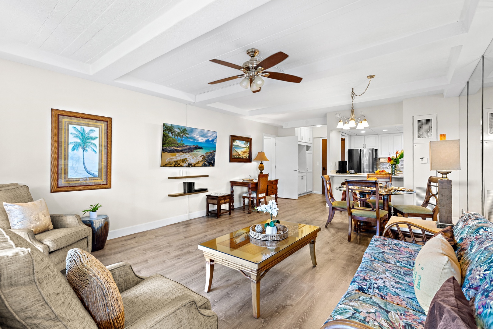 Relax in your spacious open living area, where bright island decor, ceiling fans, and a seamless flow from lounge to dining and kitchen create the perfect setting for your vacation memories.