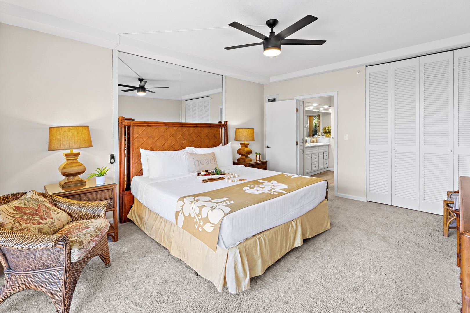 Sink into crisp white linens on your inviting bed and feel instantly at ease in this serene, island-inspired bedroom with warm tropical touches and soothing neutral tones.
