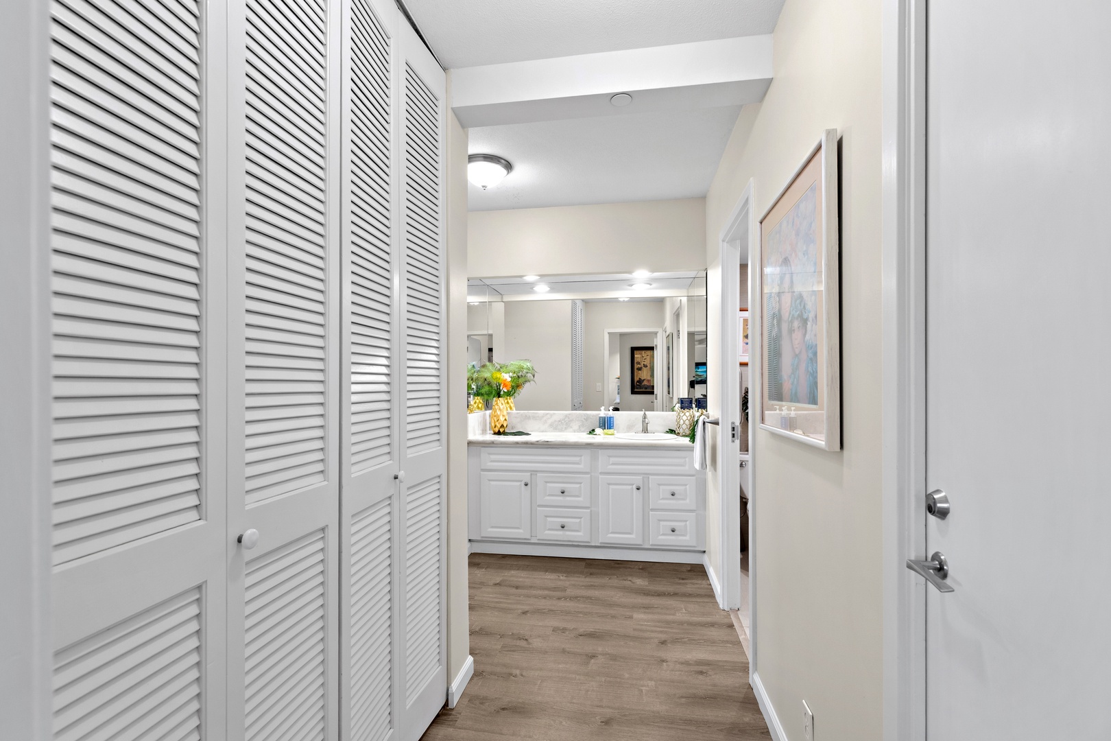Your private retreat features a spacious bathroom with dual vanities and elegant finishes, accessible through your walk-in closet with louvered doors for optimal storage and privacy.
