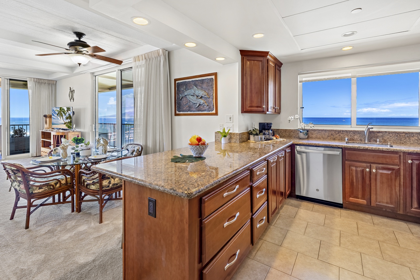 You'll love preparing meals in this fully-equipped kitchen with gleaming granite countertops and stunning ocean views. The open layout connects you to the dining area and breathtaking panoramic vistas.