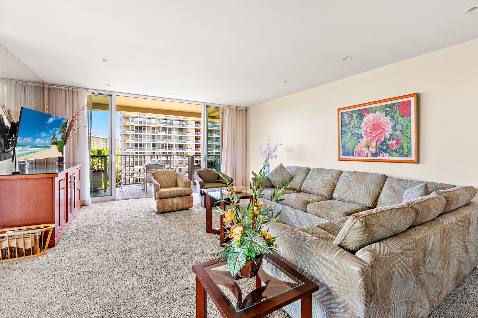 Sink into the plush sectional and let the coastal breeze flow through your open balcony doors—your serene retreat awaits with soft natural light and tranquil views.