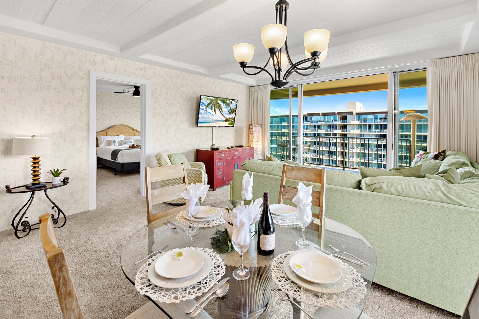Sun-drenched coastal retreat with open balcony doors, elegant dining for sunset meals, plush seating, and ocean views to soothe your days.