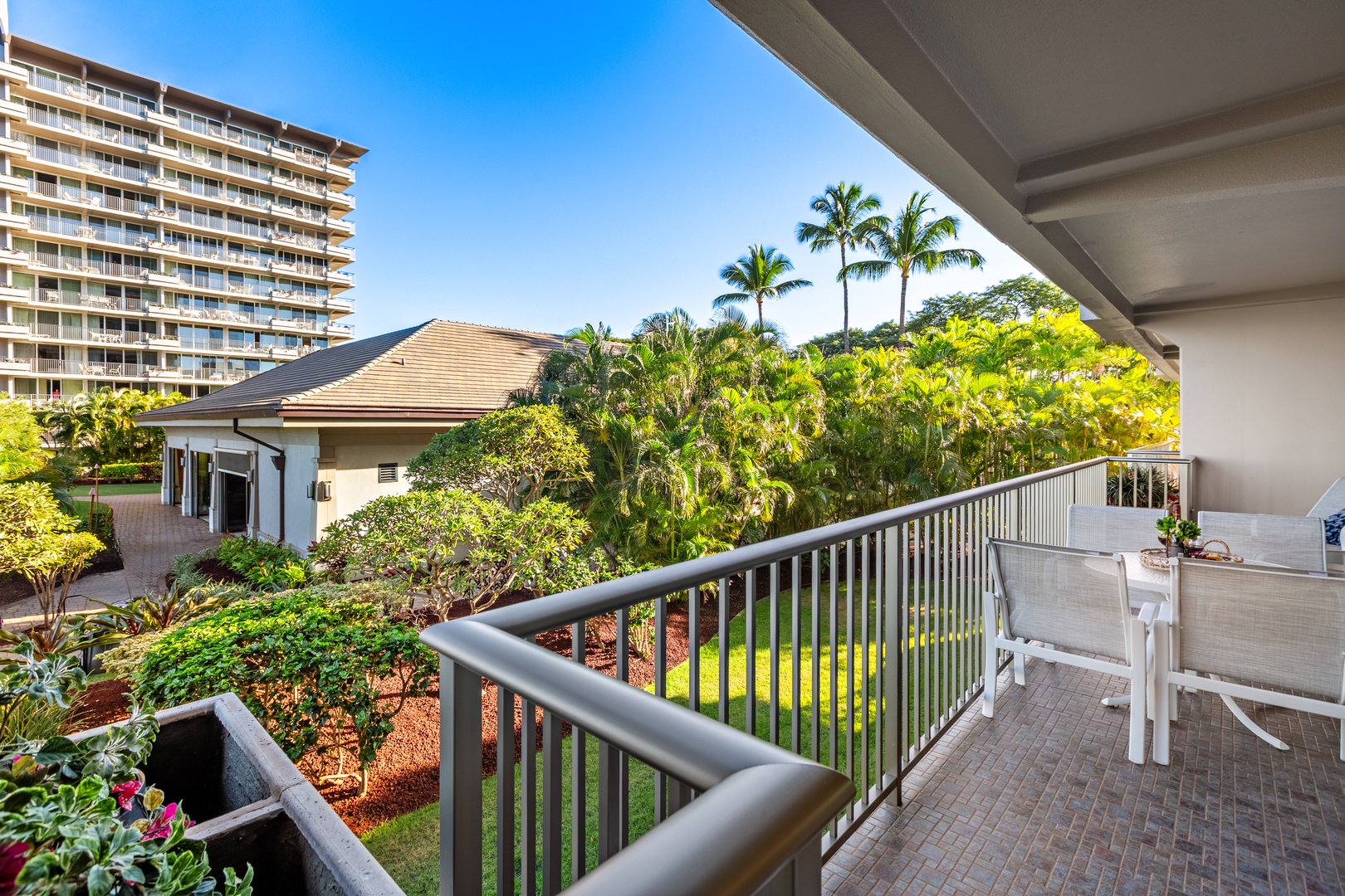 Unwind in comfortable outdoor seating as the island’s lush peaks and golden skies create the perfect peaceful escape.