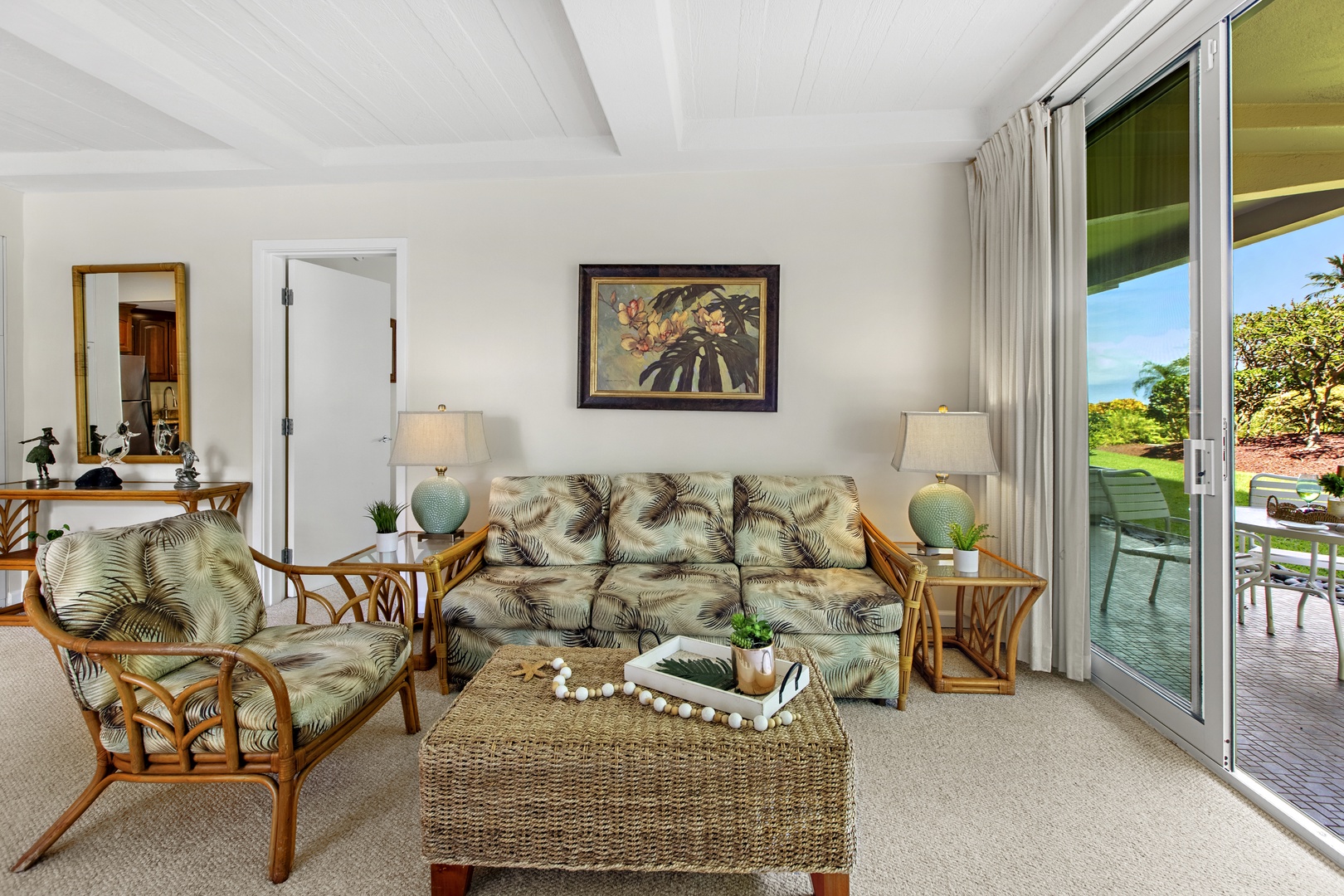 Relax in your tropical-themed living room with rattan furniture and sliding doors opening to your private outdoor space.