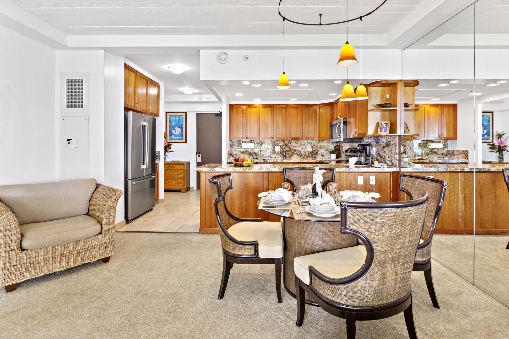Your open-concept living flows seamlessly from kitchen to dining, where warm wood cabinets and granite create an inviting space for memorable meals.