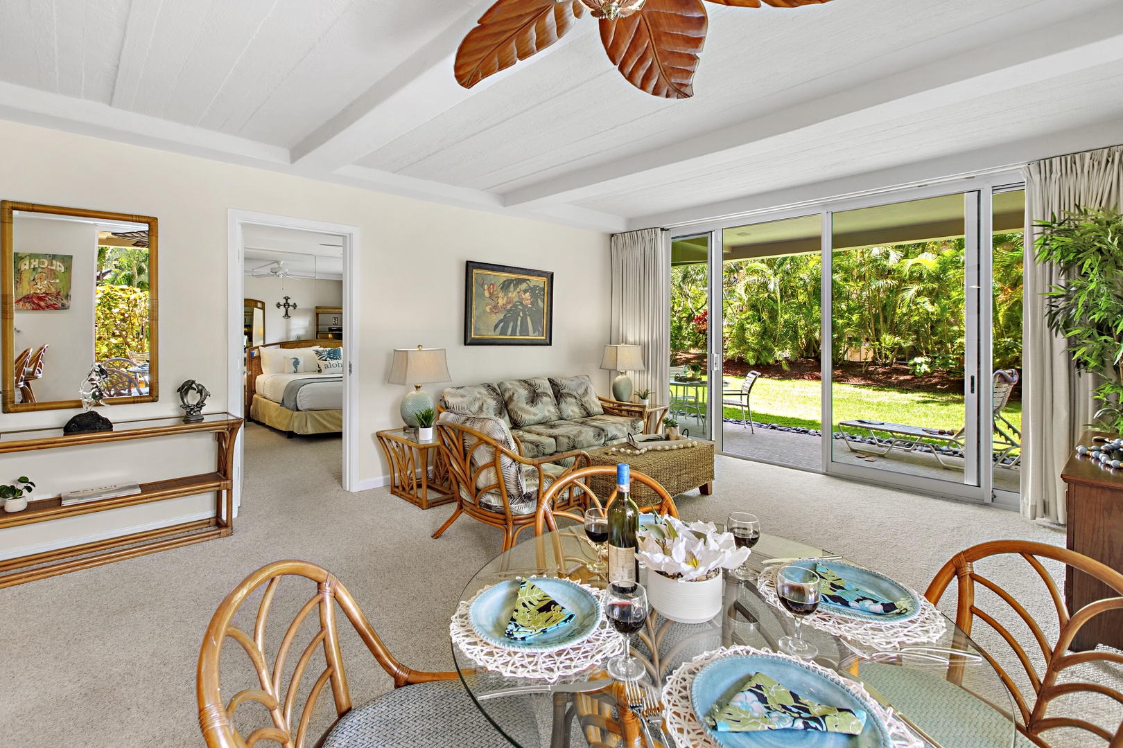 Relax in your tropical open-plan living space with garden views through sliding doors and island-inspired decor.