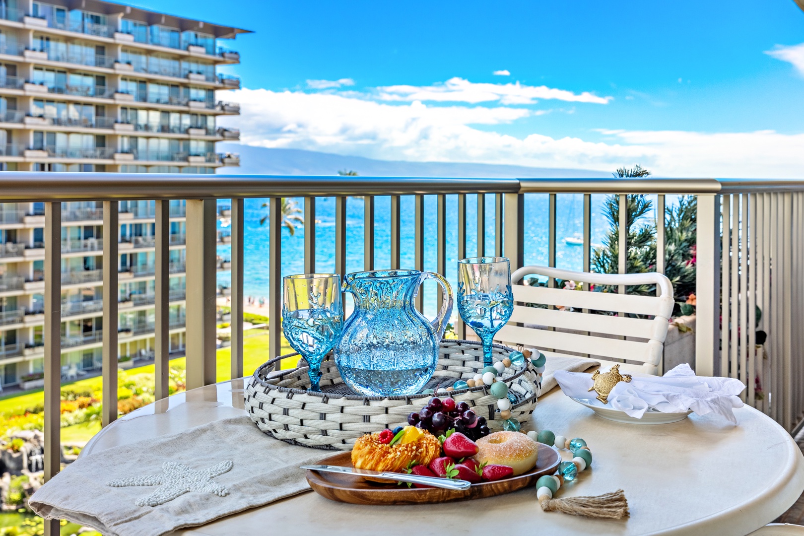 Savor your morning coffee and fresh fruit on your private balcony overlooking sparkling turquoise waters and lush resort grounds—the perfect start to your beach getaway.
