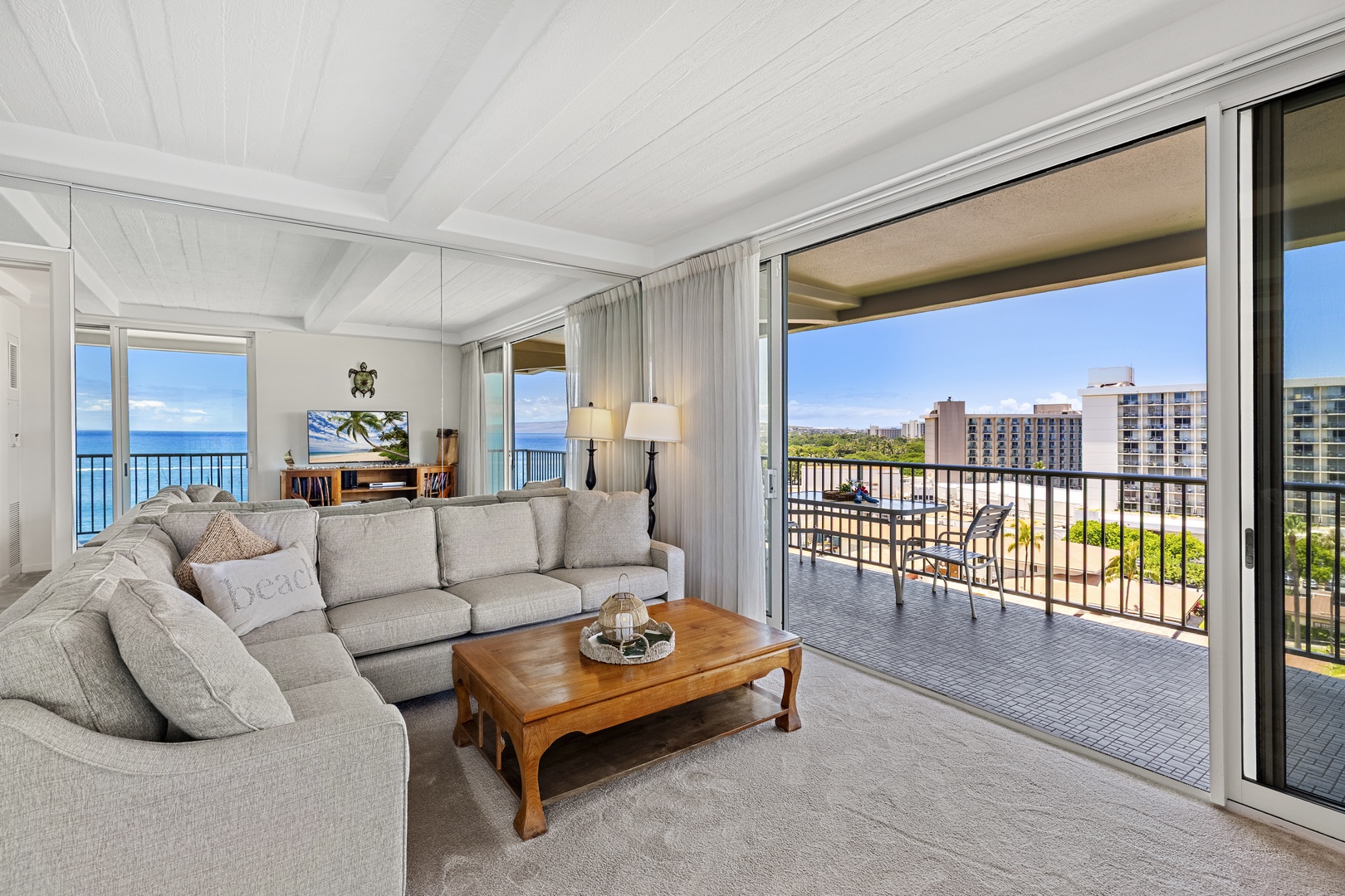 Step into your bright coastal retreat with sweeping ocean and city views through floor-to-ceiling doors. Relax on plush seating or enjoy your private balcony overlooking paradise.