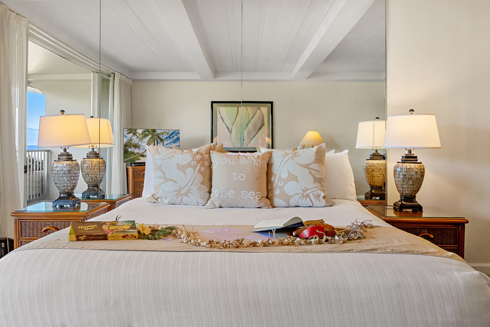 Spacious island-inspired retreat featuring a comfortable king-size bed, rich wood furnishings, cozy tropical accents, and a bright inviting bedroom space.
