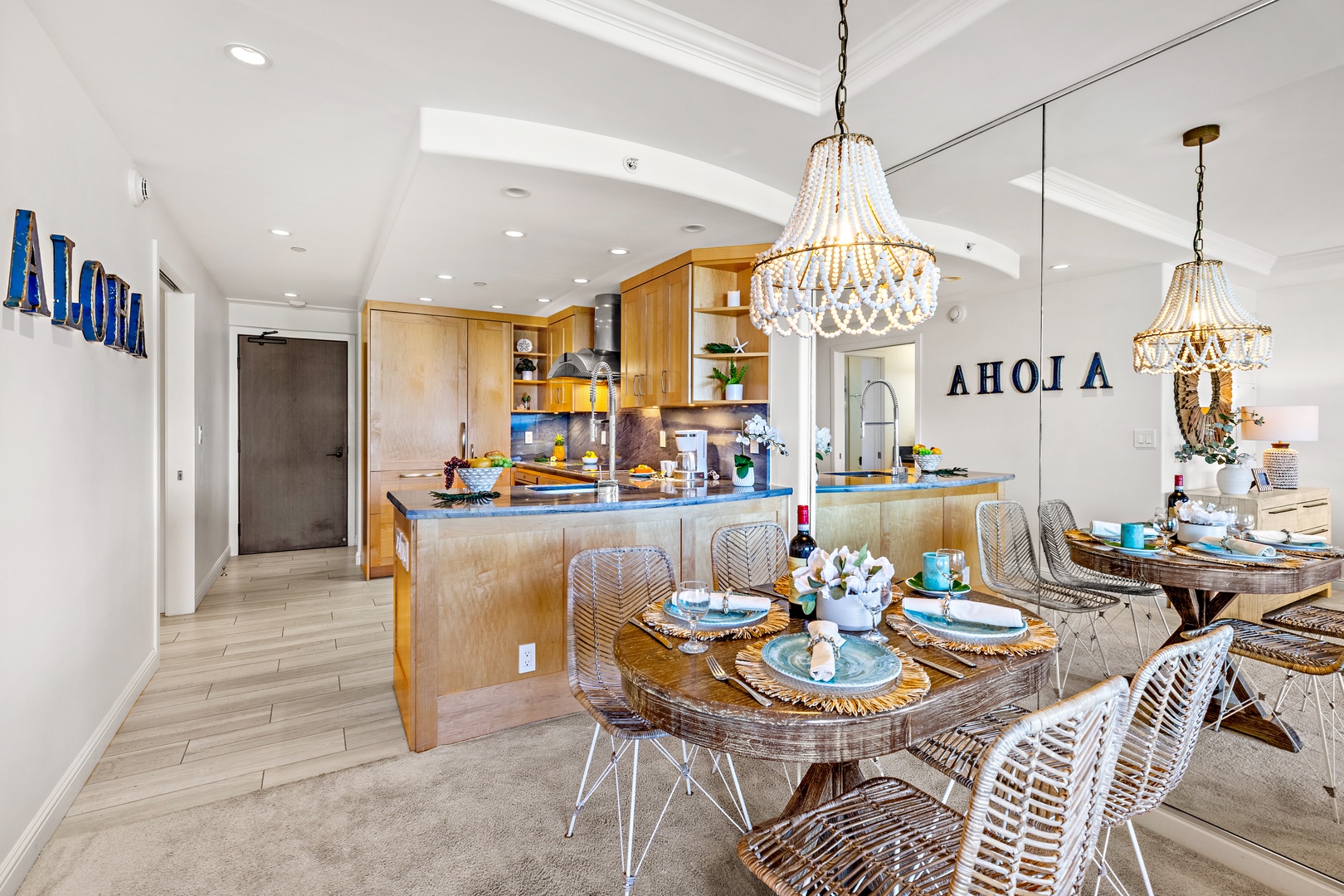 Gather around the inviting dining table with coastal décor, then step into your fully equipped kitchen where sunlight and stylish fixtures set the scene for memorable meals together.