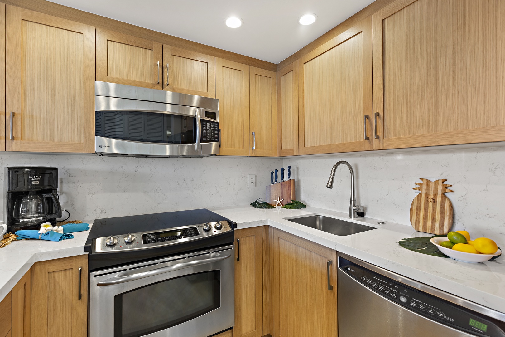 A fully equipped kitchen awaits you with modern stainless steel appliances, quartz countertops, and light wood cabinetry. Your home away from home has everything you need to prepare meals together.