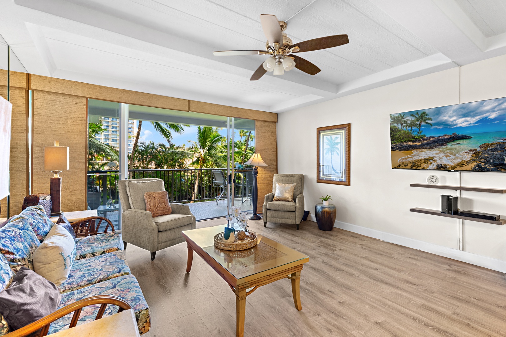 Picture yourself relaxing in this airy living room with tropical views framed through the balcony doors. Plush seating, coastal décor, and gentle ceiling fan breezes create your perfect island retreat.