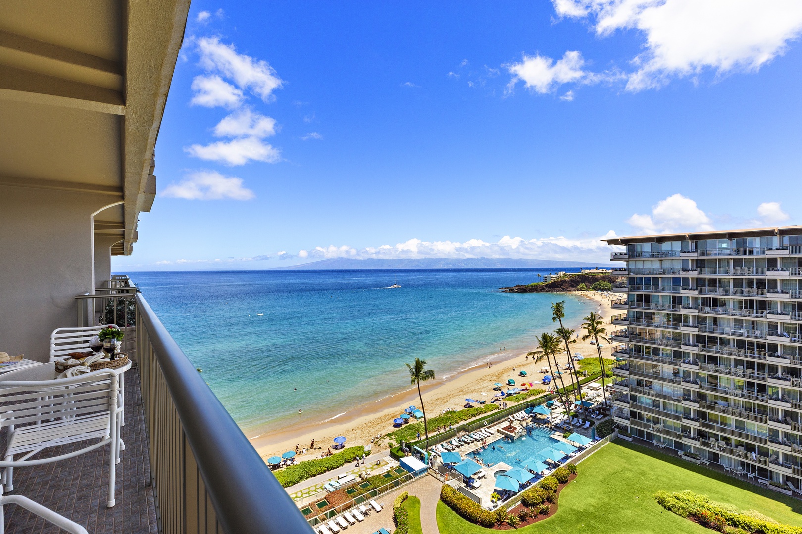Stunning oceanfront views and direct beach access await your Hawaiian getaway, with a sparkling pool and lush gardens just steps from your private balcony.