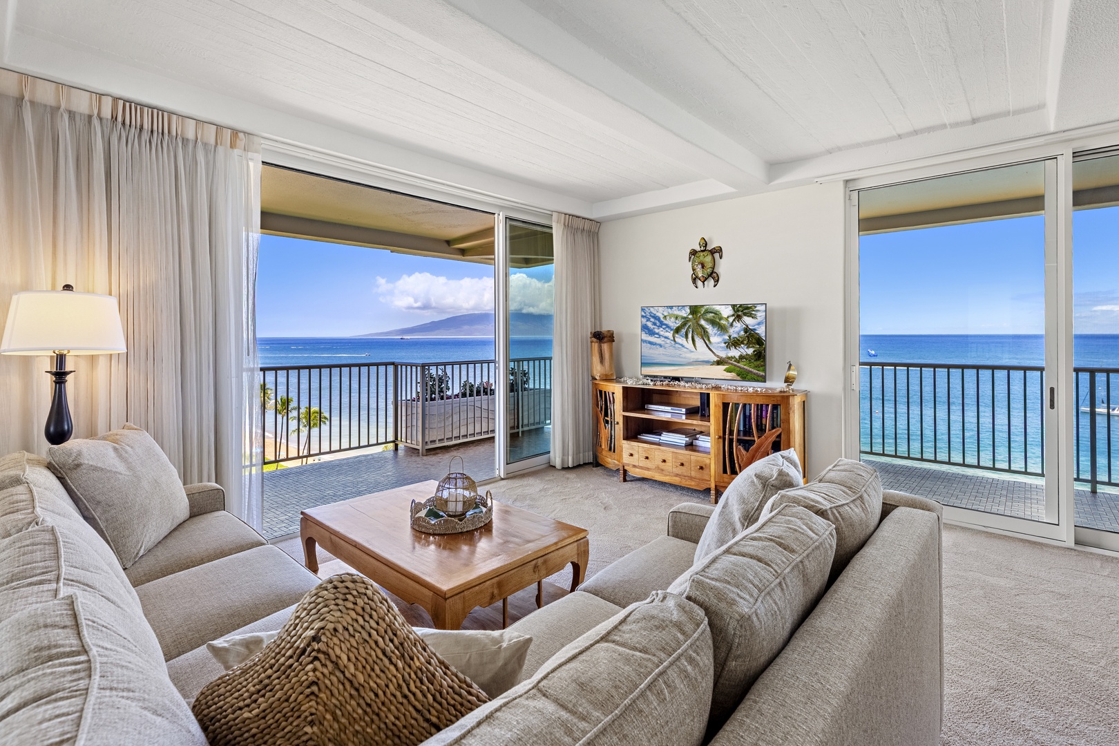 Unwind in this bright living room where panoramic ocean views frame your relaxation. Step out to the private balcony and soak in sweeping coastal scenery from sunrise to sunset.