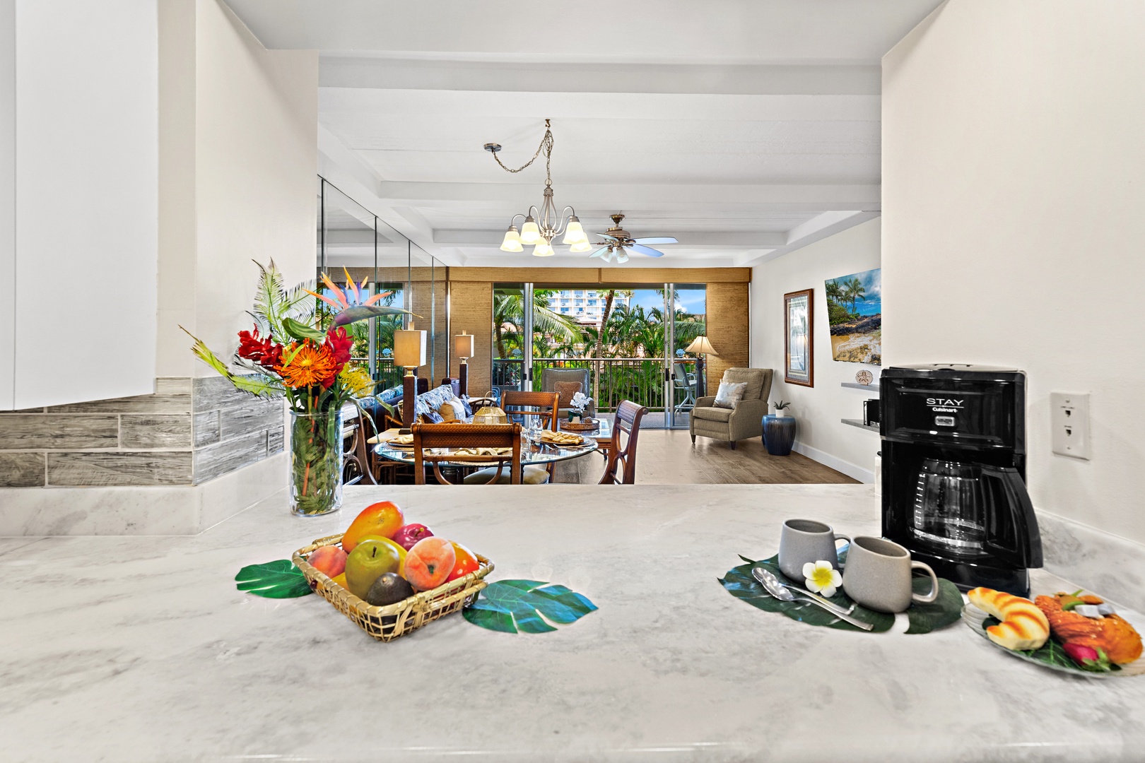 Step into your tropical retreat where morning coffee meets island views. The open layout connects a well-equipped kitchen to a bright living space, with fresh fruit and tropical touches welcoming you home every day.