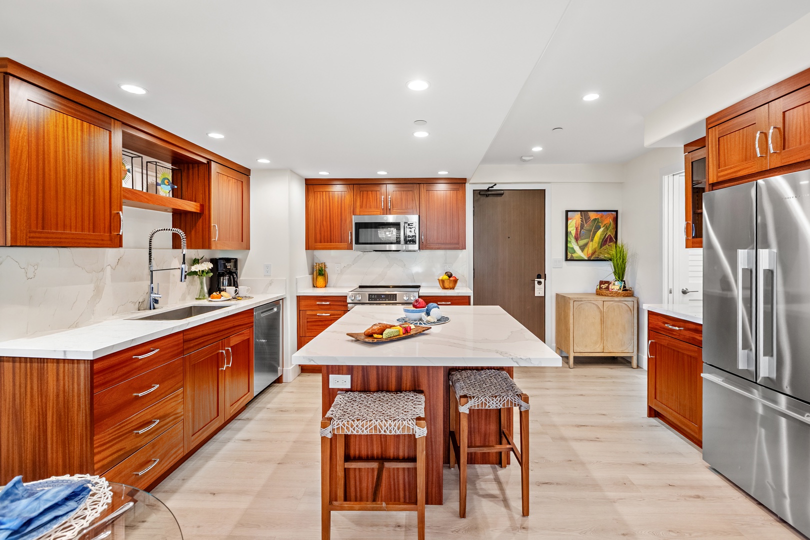 Your gourmet kitchen awaits with rich wood cabinetry, counters, and stainless-steel appliances. Perfect for preparing memorable meals together.