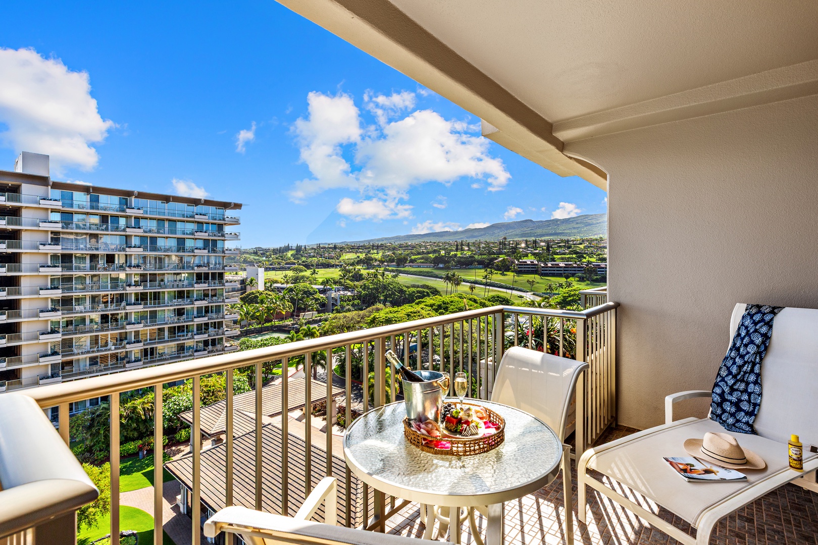 Sip morning coffee on your private balcony while taking in sweeping views of lush golf greens, rolling mountains, and neighboring resort architecture under open blue skies.