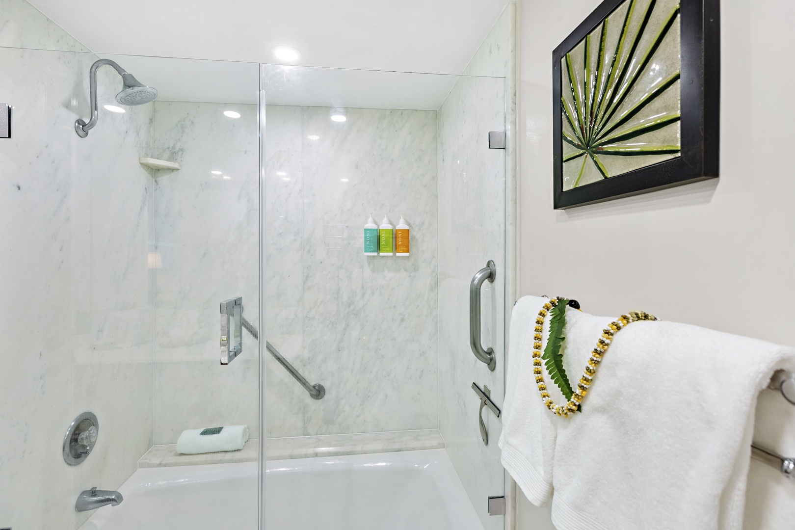 A beautifully appointed guest bathroom designed with comfort and convenience in mind. Featuring warm granite countertops, natural wood cabinetry, and soft, neutral tones, the space offers a clean and inviting atmosphere.
