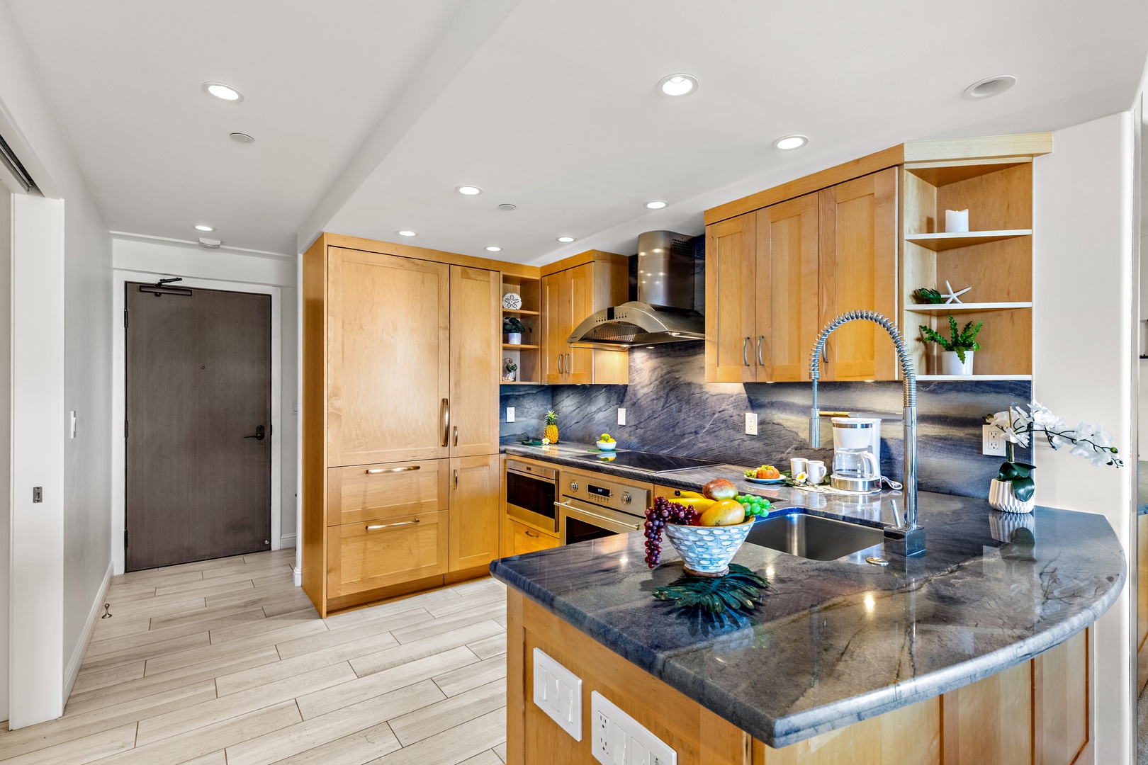 You'll love preparing meals in this bright, modern kitchen with warm wood cabinetry, sleek granite counters, stainless steel appliances, and an open layout perfect for gathering.