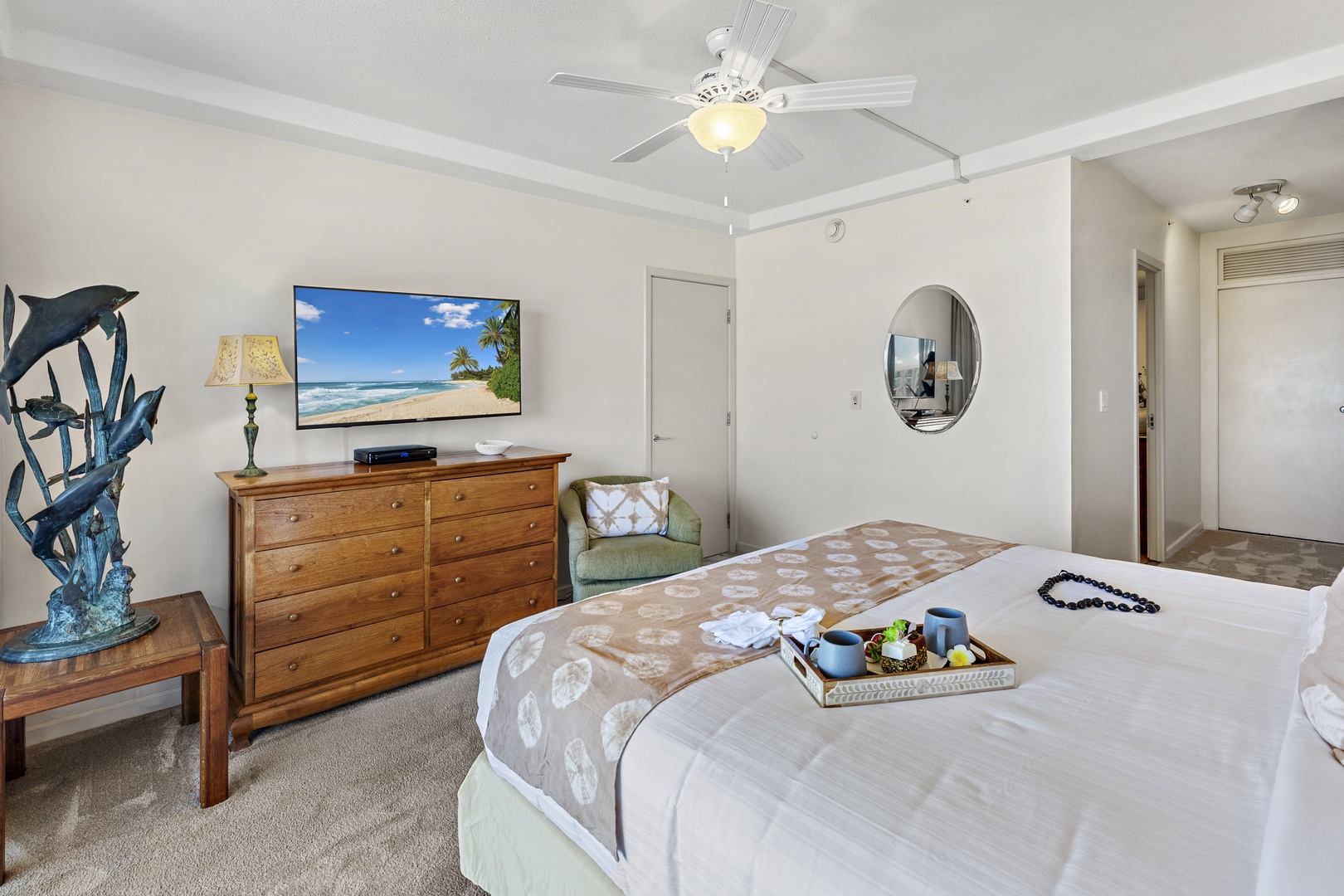 Unwind in your serene bedroom with coastal charm. A plush bed, entertainment center, and bright, airy design create your perfect beachside escape after a day of sun and adventure.