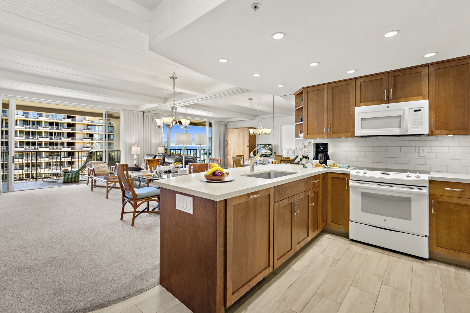 Modern kitchen with granite countertops, center island, and generous prep space, opening to the main living area.