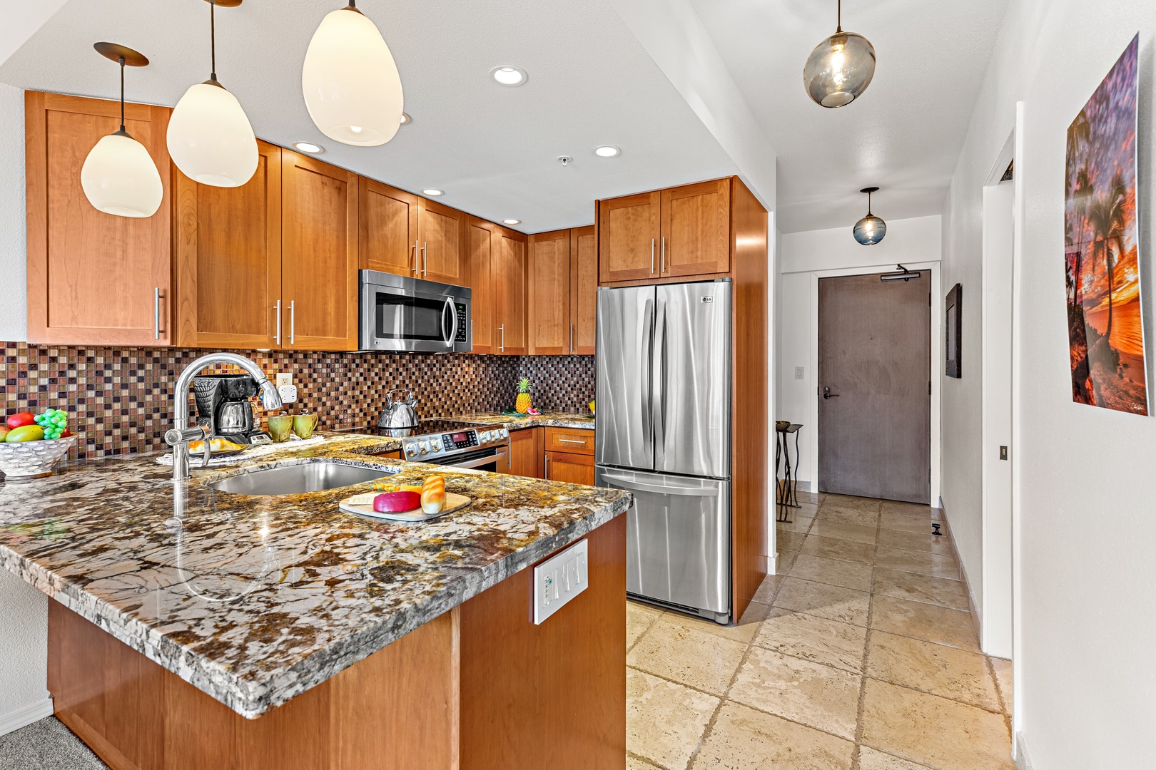 Cook your favorite meals in your fully equipped kitchen, featuring stainless steel appliances, granite countertops, and stylish pendant lighting. The island offers extra prep space and a casual spot to enjoy breakfast.