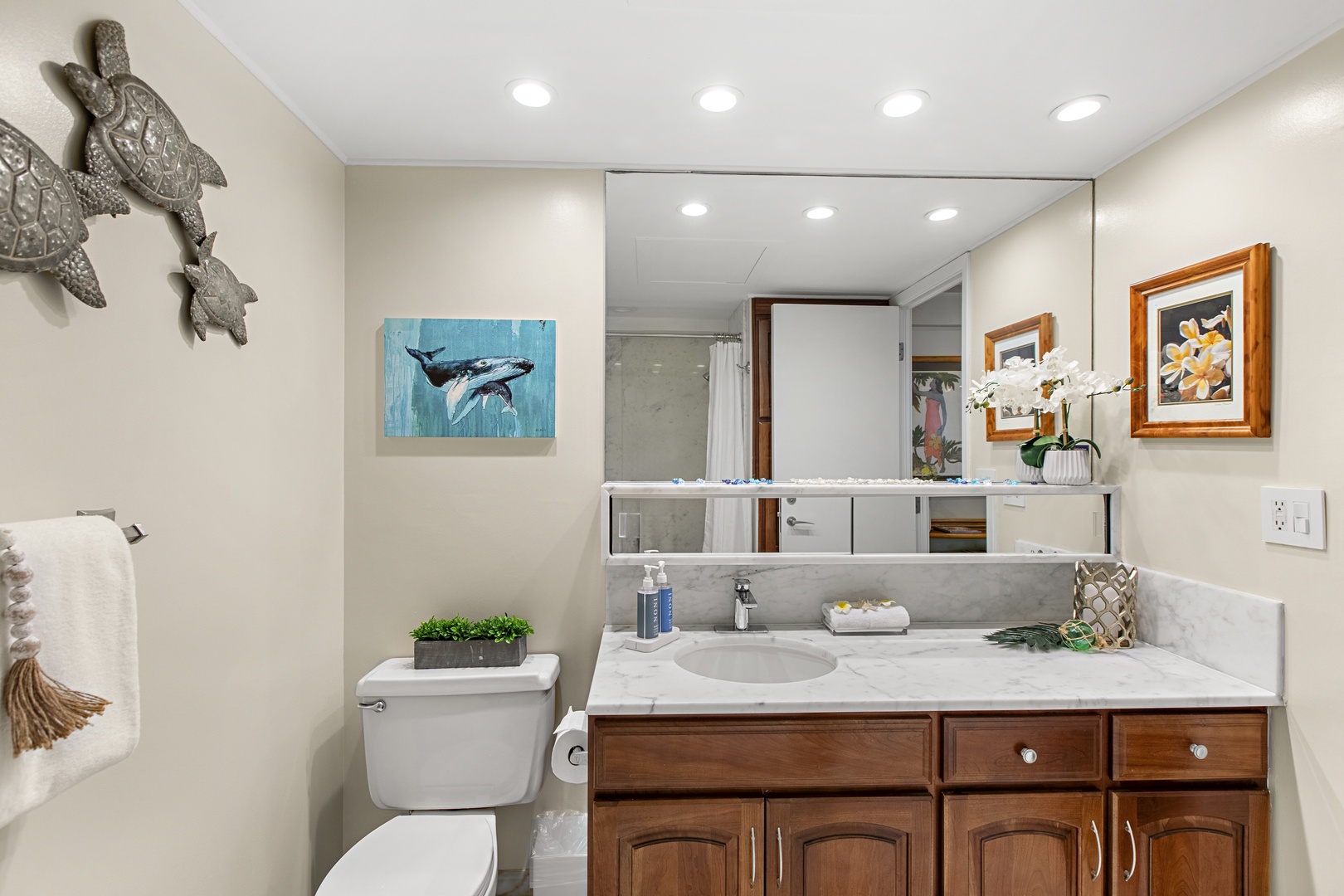 Refresh in your beautifully appointed bathroom with ocean-themed touches, marble countertops, and thoughtful amenities that make your stay feel like home.