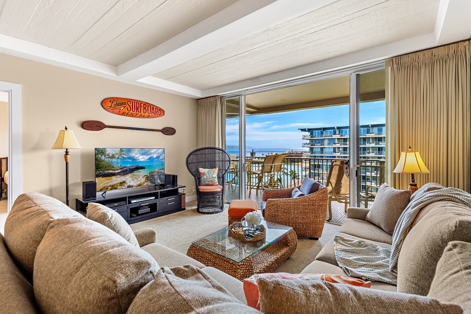 Relax in your coastal-themed living room with ocean views from your private balcony and cozy beach-inspired furnishings.