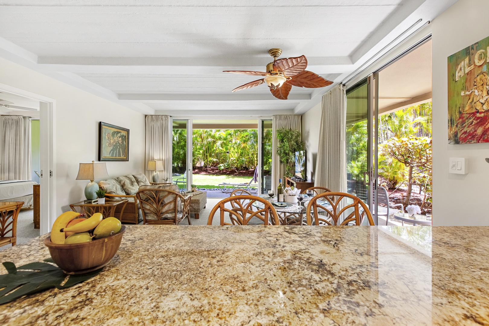 Your open-plan living space blends indoor comfort with tropical views, where granite countertops and natural light create the perfect gathering spot.