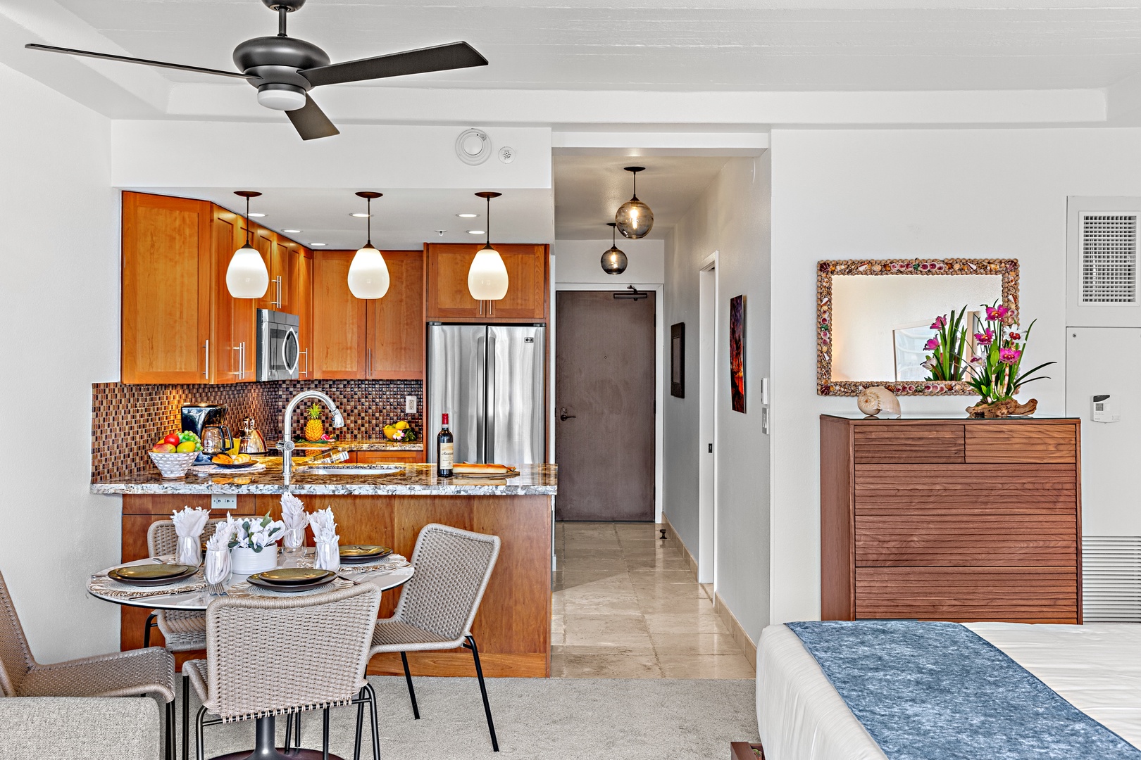 Step into your bright, open-concept living space where modern comfort meets island charm. The fully equipped kitchen invites you to cook and gather with loved ones around the dining table.