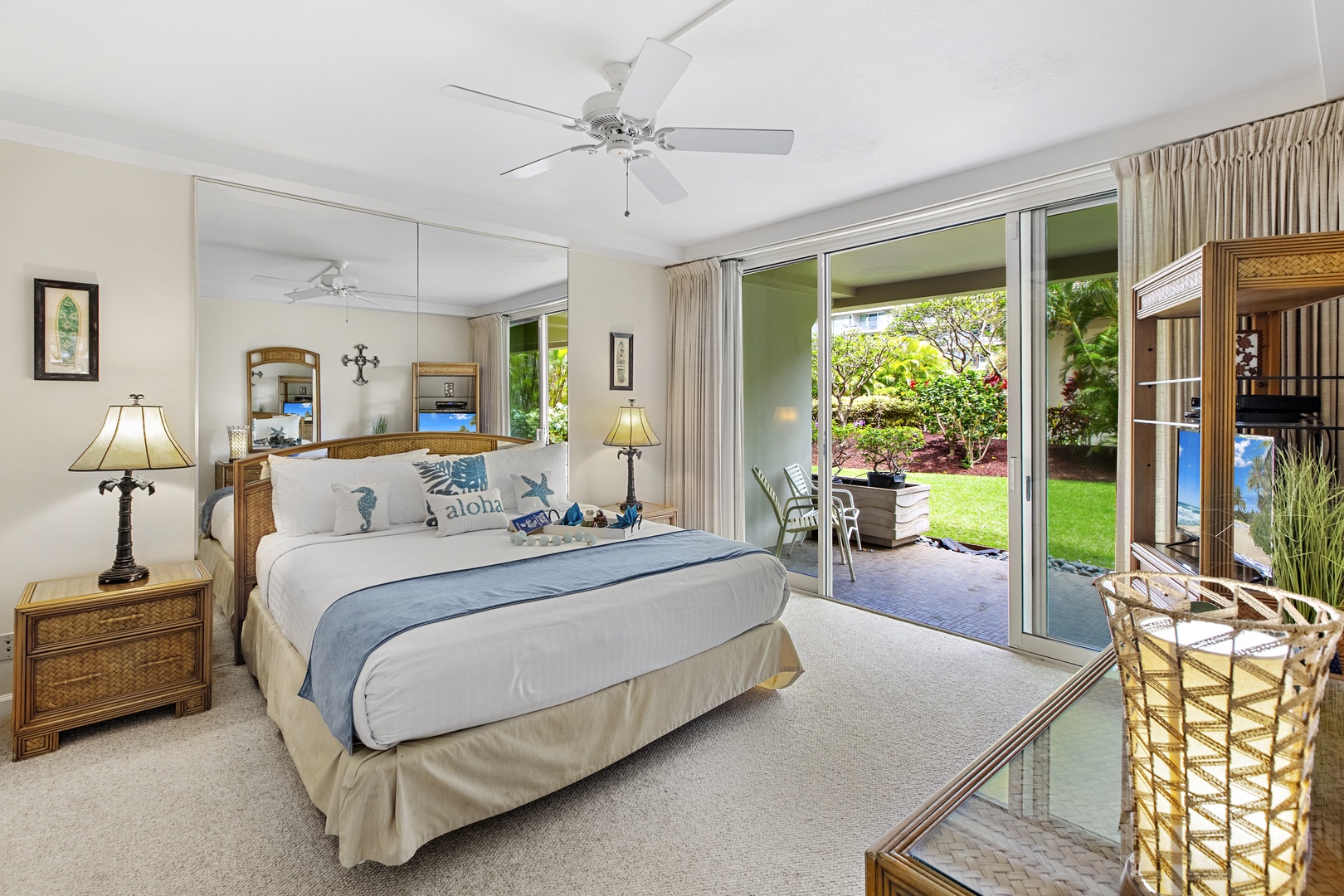 Your serene bedroom opens to tropical gardens, where gentle breezes through sliding doors create the perfect Hawaiian escape.