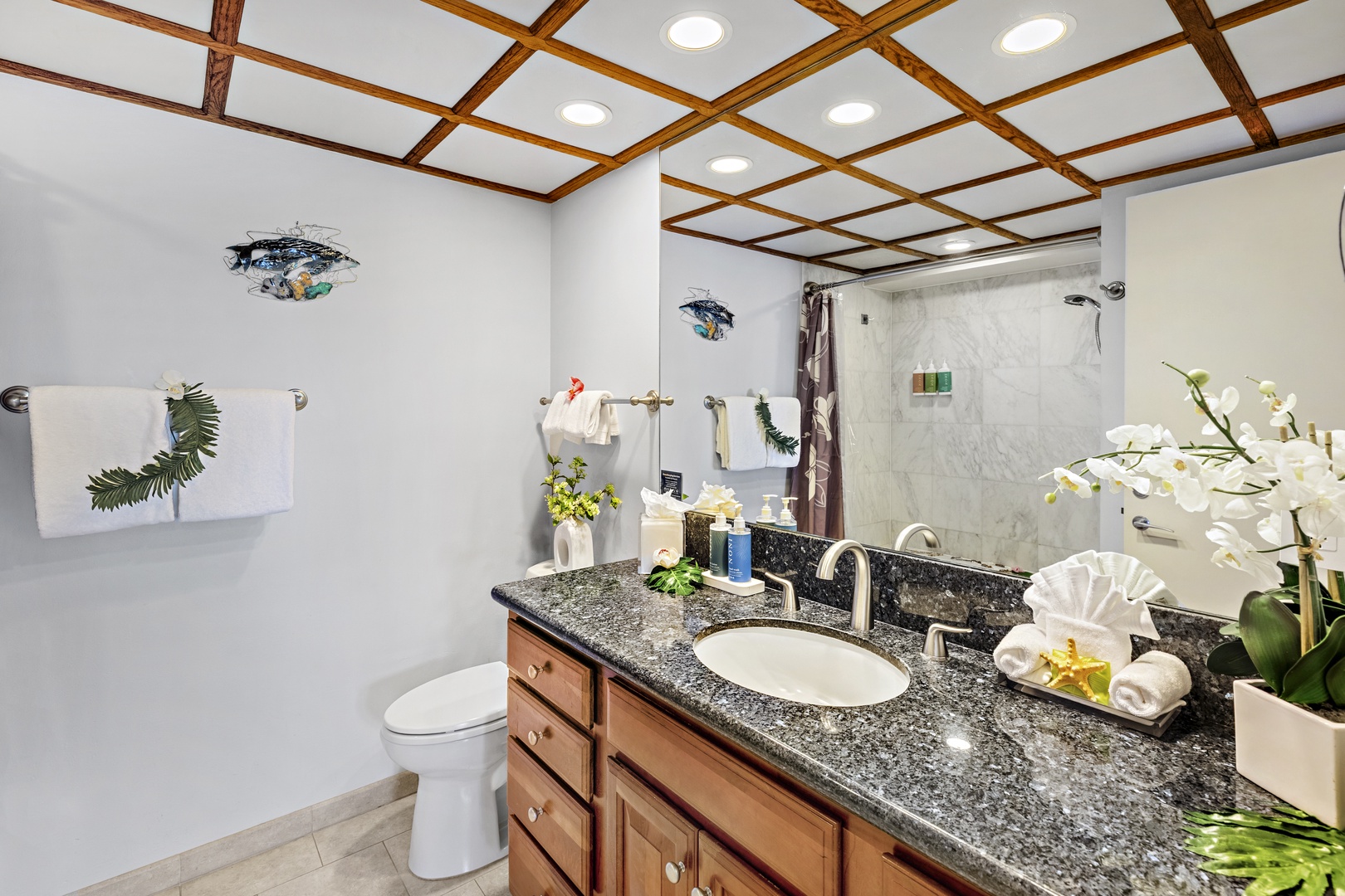 Step into your private bathroom oasis, where a granite vanity, fresh towels, and tropical touches create a spa-like retreat you'll love unwinding in after each day.