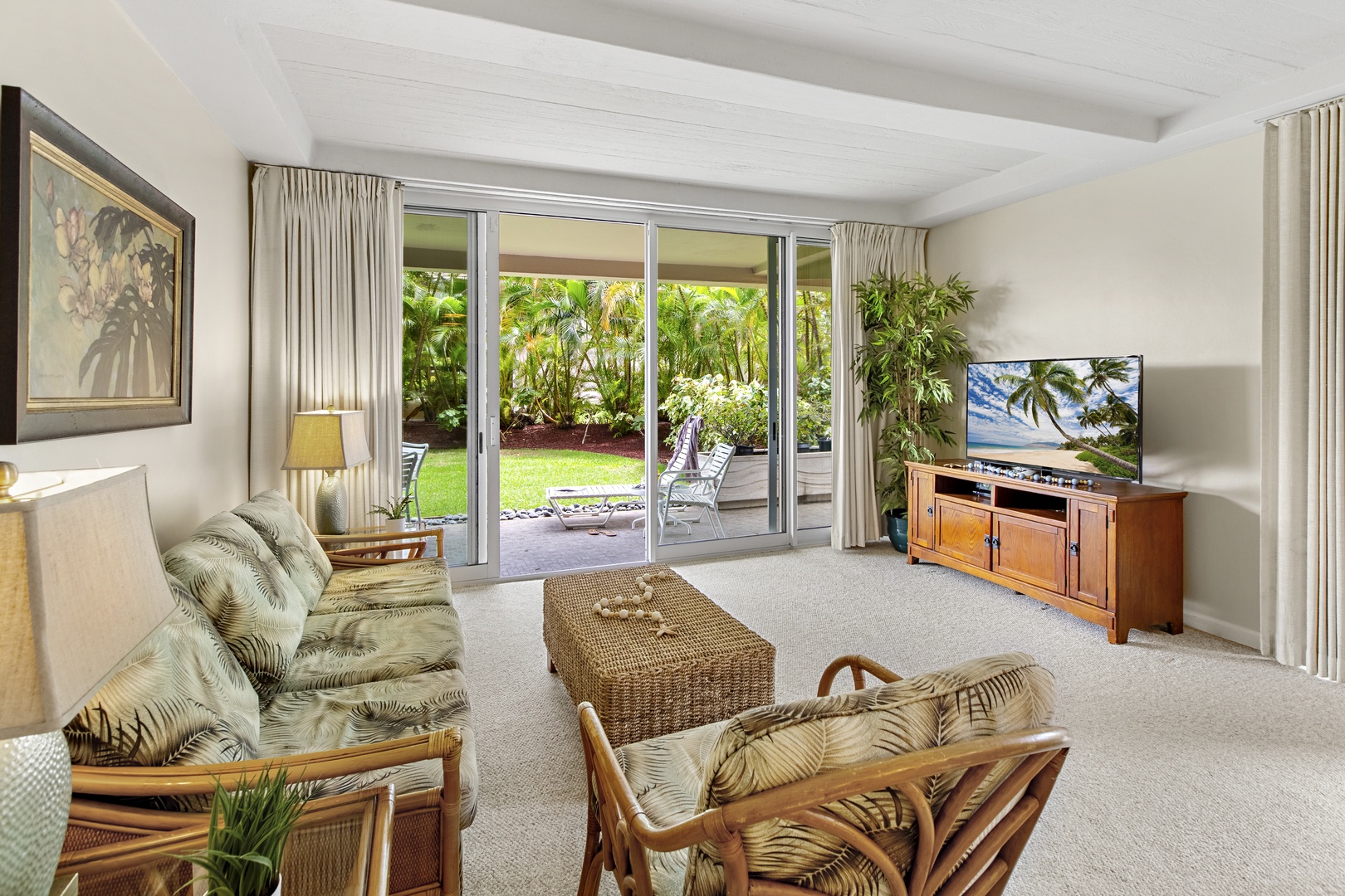 Relax in your tropical living room with garden views through floor-to-ceiling doors opening to your private patio.