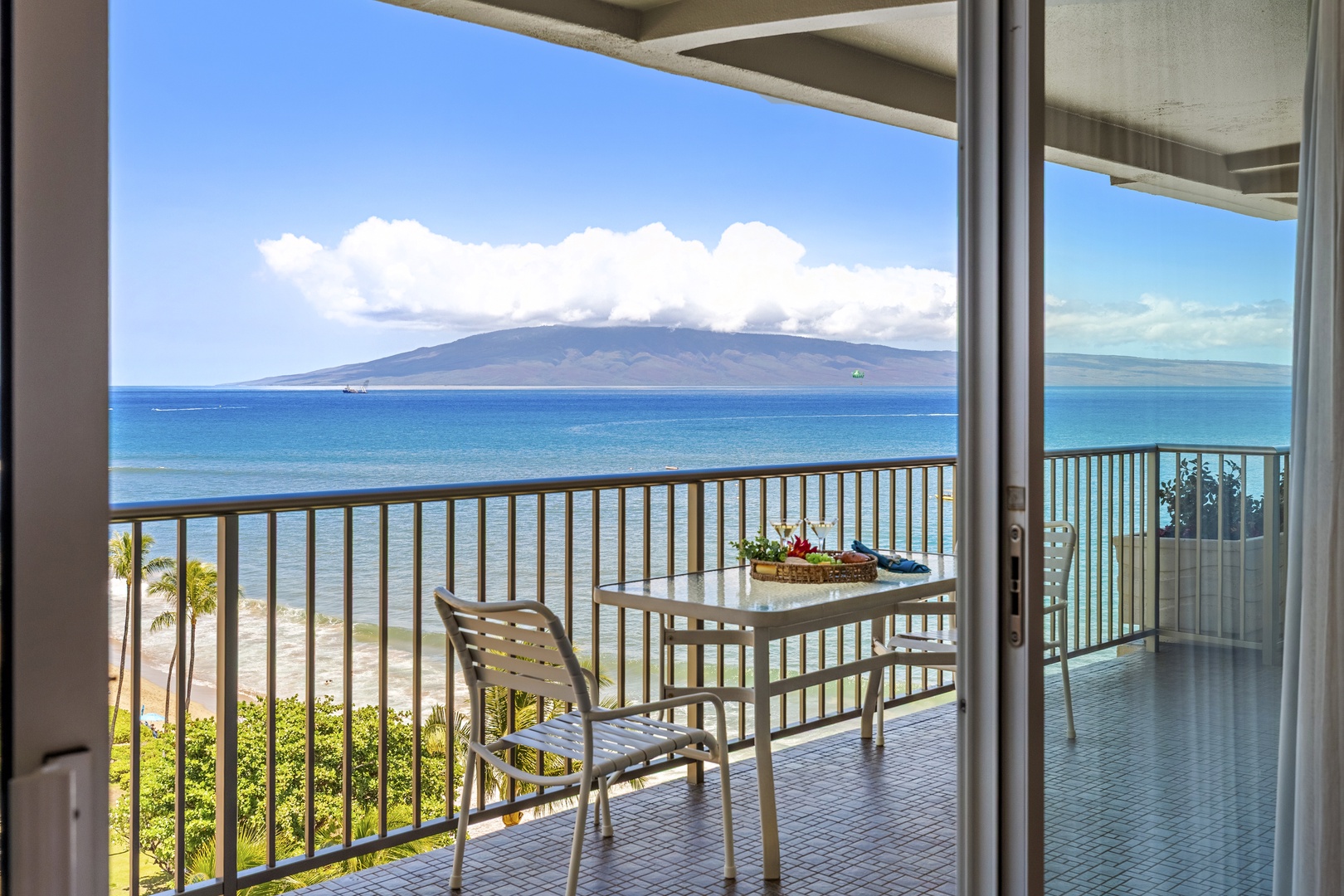 Your private balcony offers breathtaking oceanfront views where turquoise waters meet dramatic volcanic peaks. Sip morning coffee as gentle waves roll onto the sandy shore just below.