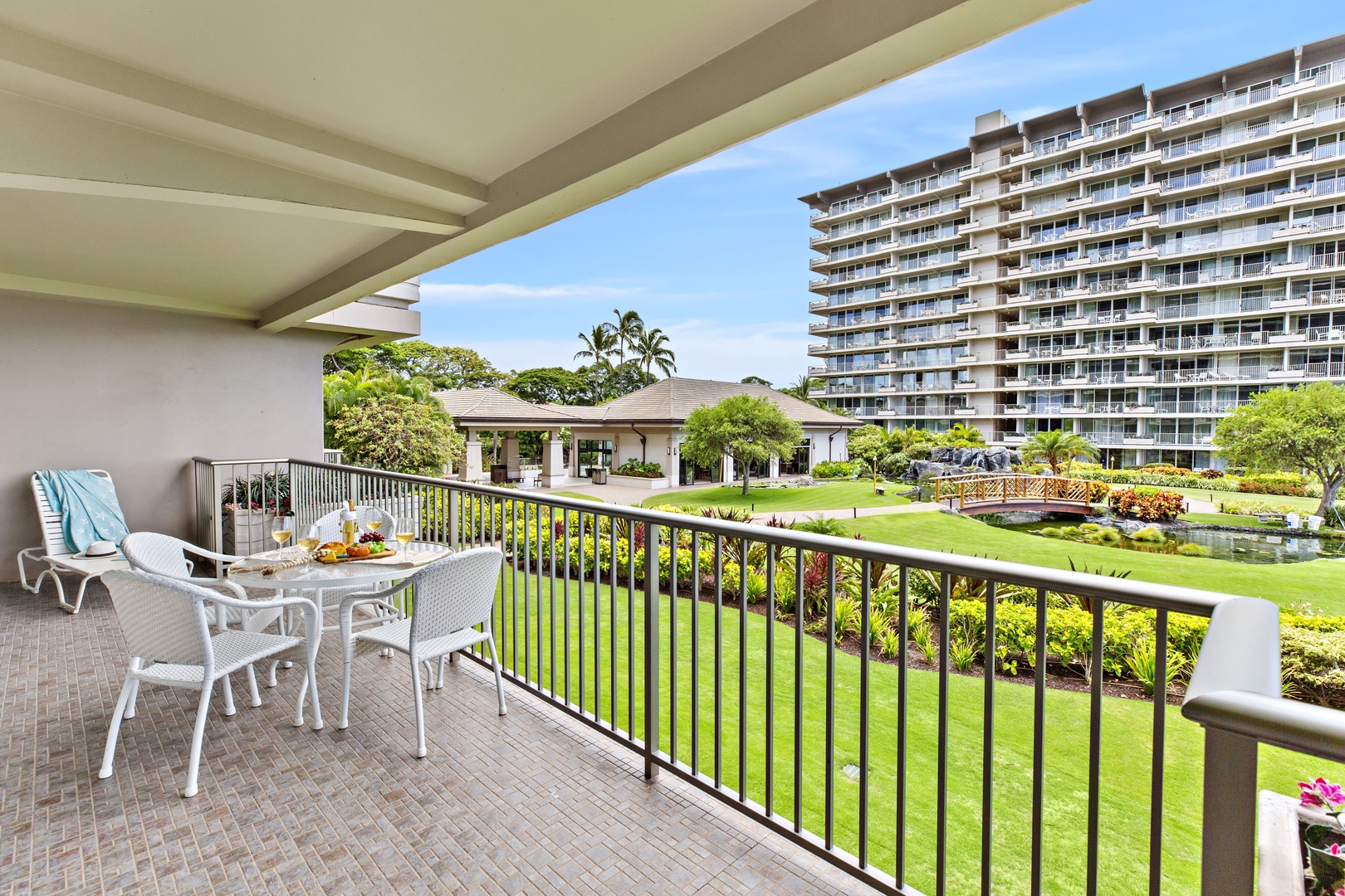 Step onto your private balcony with tropical garden views, where morning coffee tastes better surrounded by lush landscaping and palm trees.