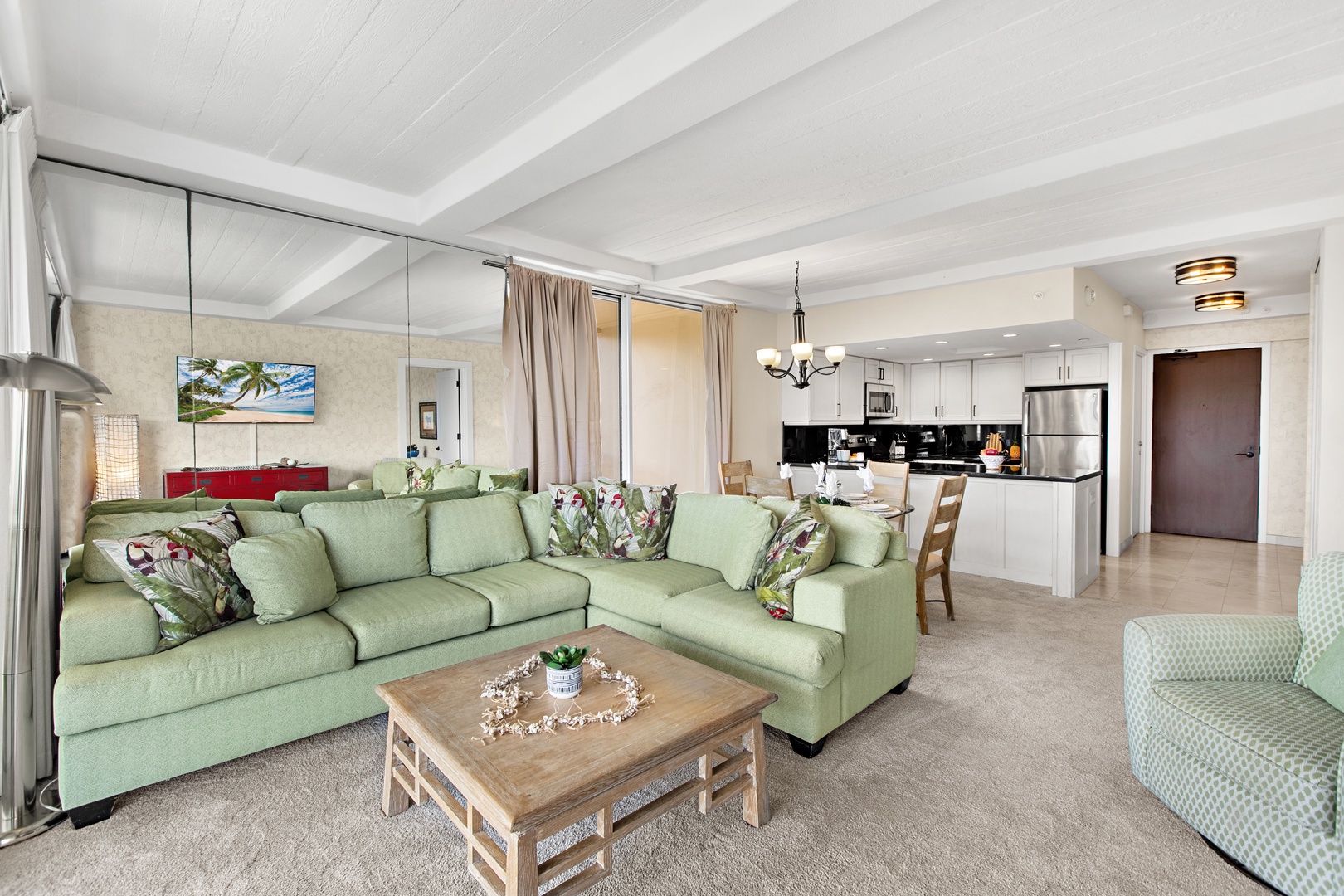Your spacious retreat awaits—sink into plush coastal-inspired seating while soaking in the airy open-plan design, complete with a fully equipped kitchen ready for your home-cooked island meals.