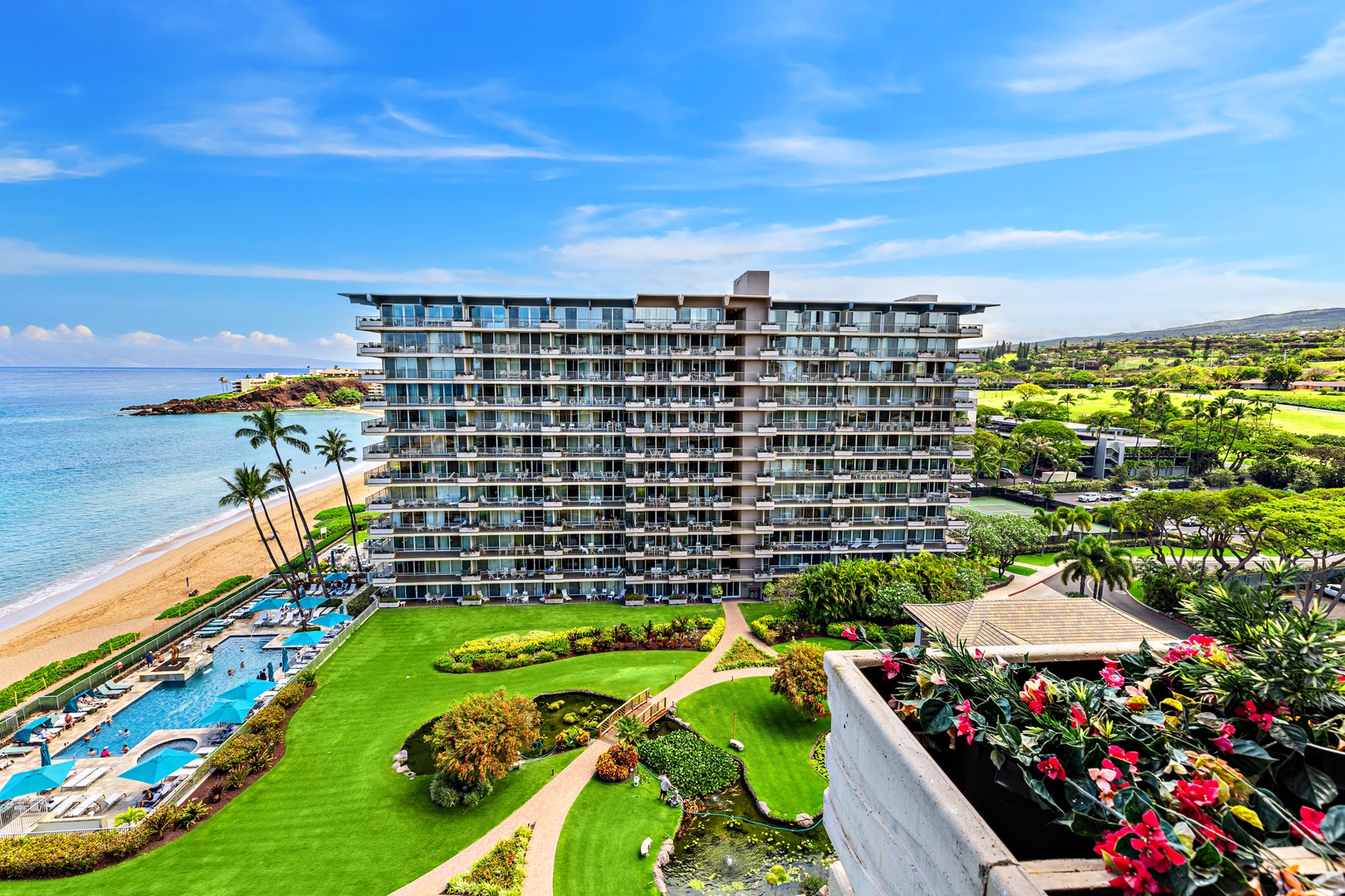 Beachfront resort with pool, landscaped grounds, and ocean access offers a tropical Hawaiian paradise experience.