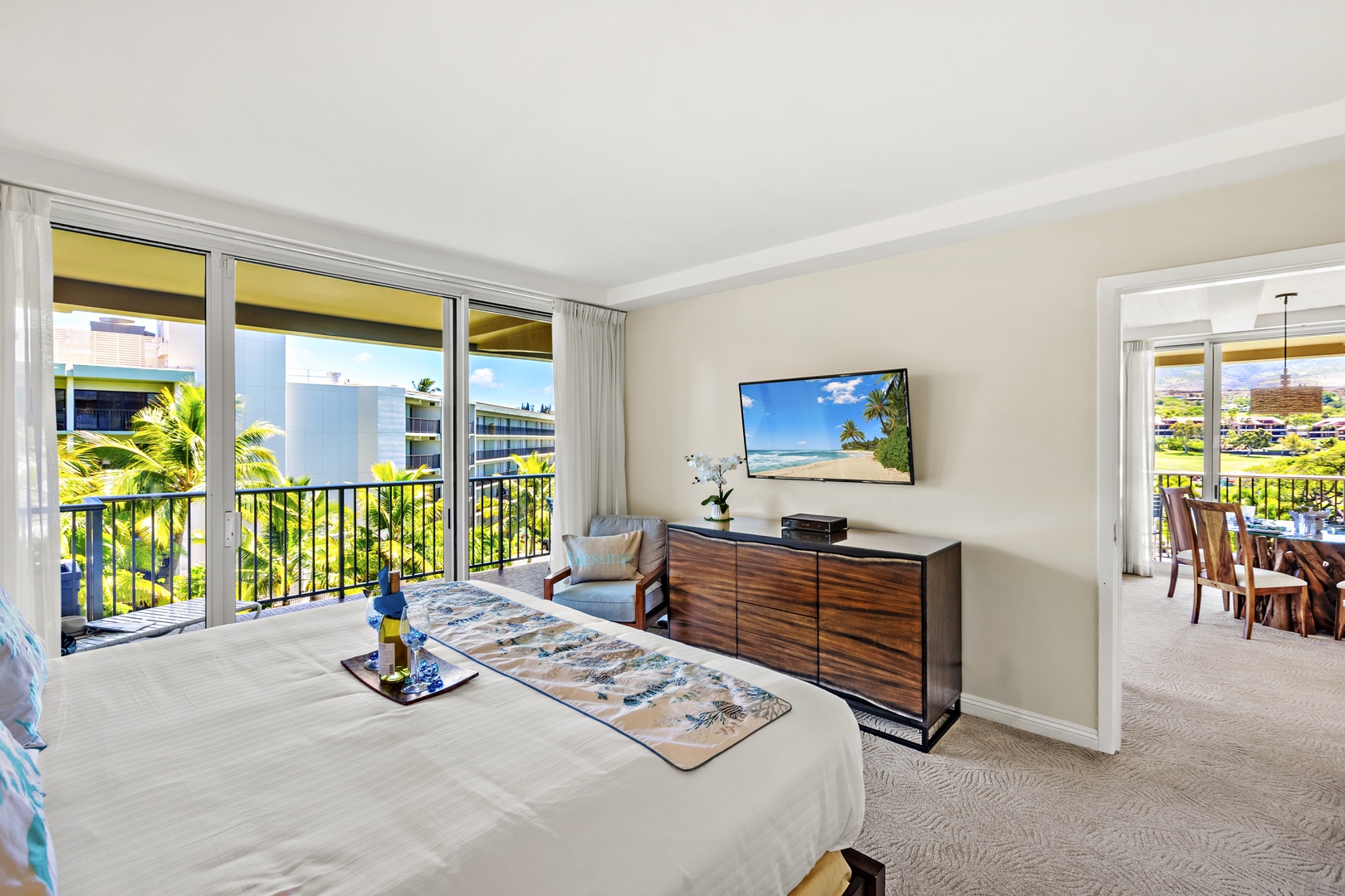 Wake up to island light and step straight out to sweeping resort views. This bright, airy bedroom opens to a private balcony, blending comfort and indoor-outdoor living in the heart of paradise.