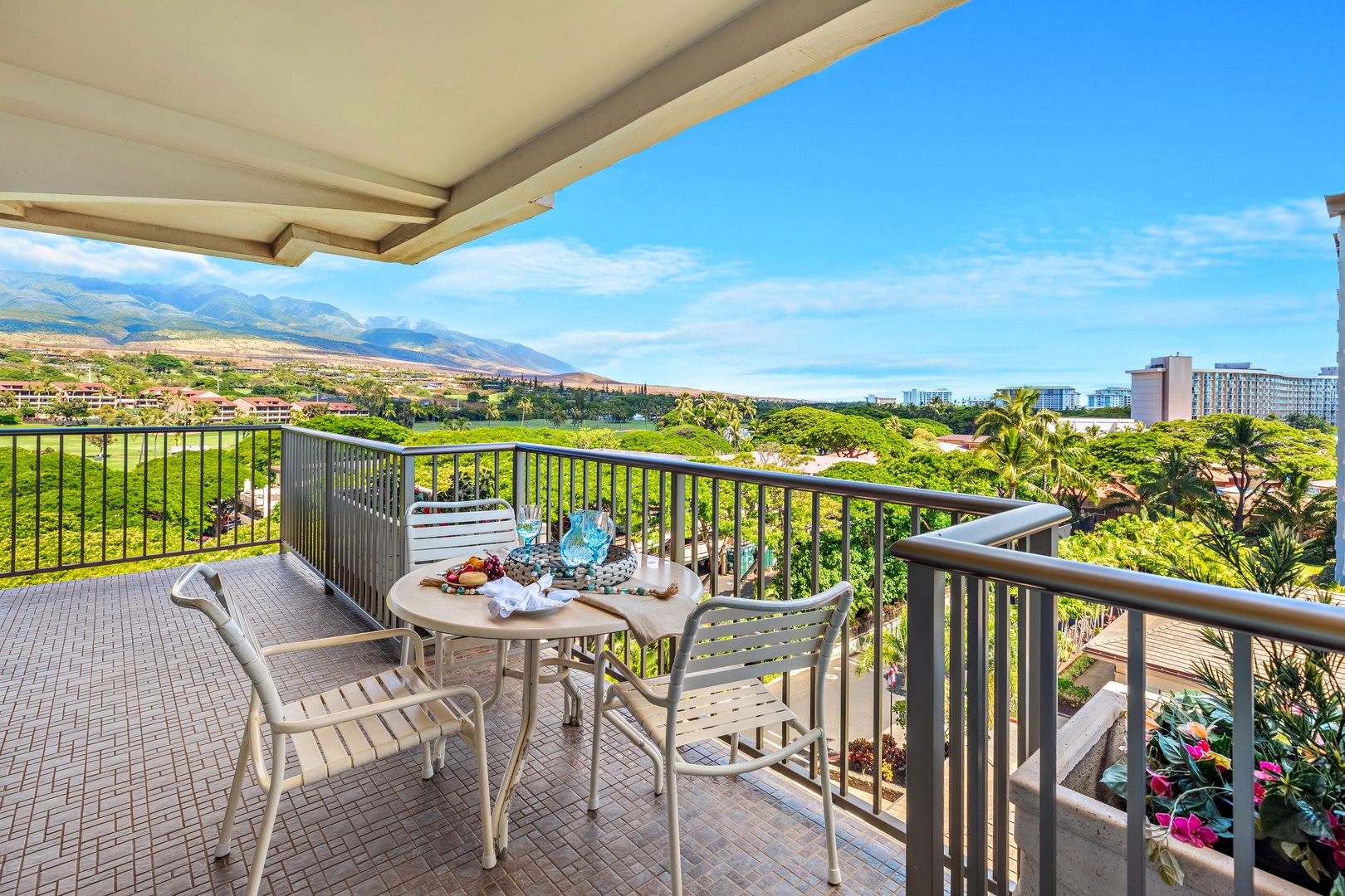 Step onto your private balcony and soak in sweeping mountain and garden views. Enjoy your morning coffee or sunset cocktails at this inviting outdoor table, surrounded by lush greenery and open skies.