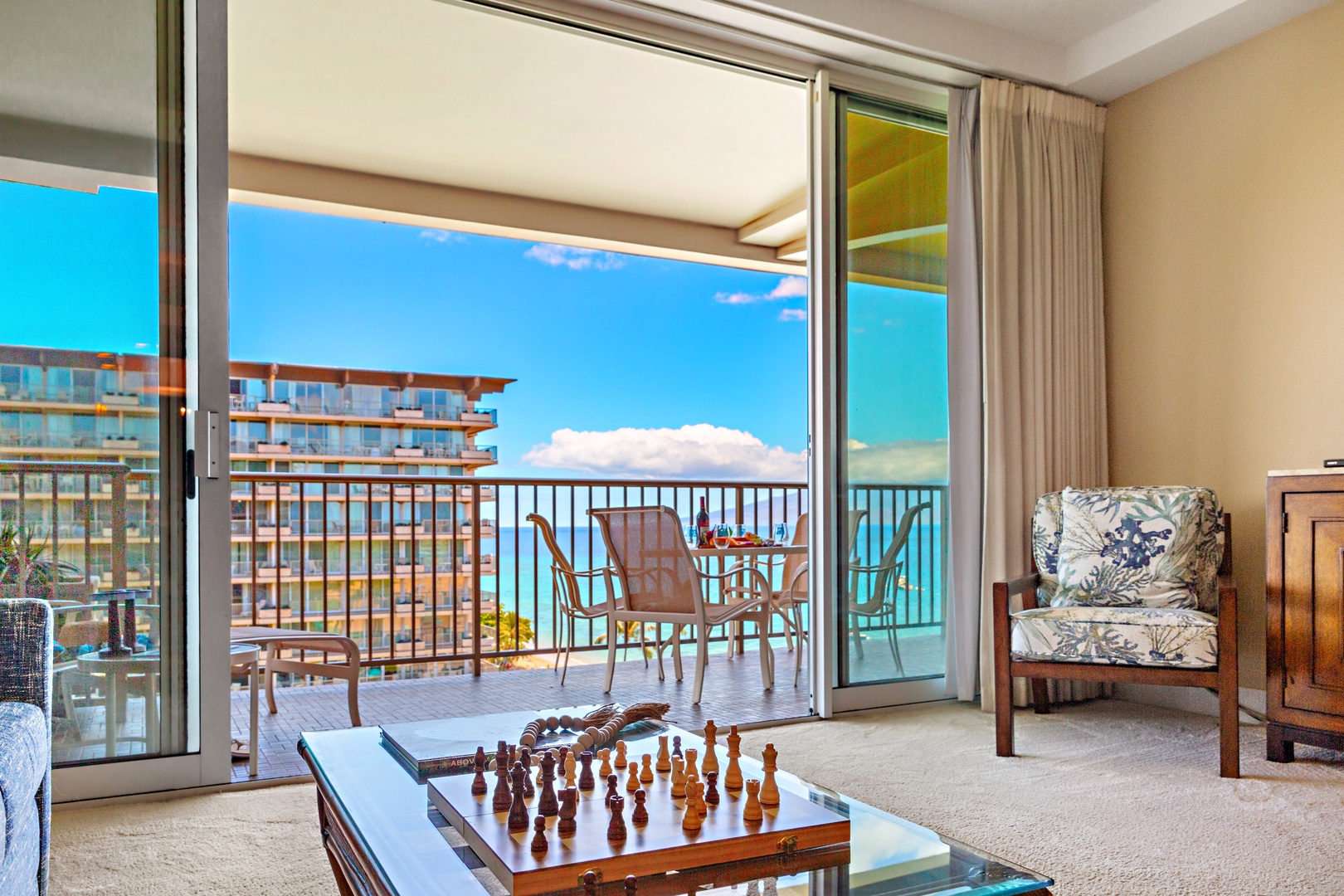 Step through the glass doors to your private balcony and soak in stunning turquoise ocean views. Relax with a game of chess inside or unwind outside where gentle breezes and endless blue horizons await.