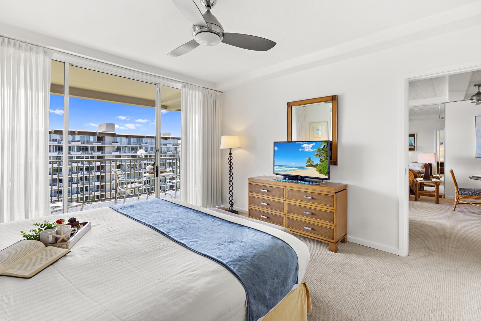 Drift off in this bright bedroom where city views frame your balcony. A cozy bed awaits, while gentle breezes from your private terrace complete the retreat.