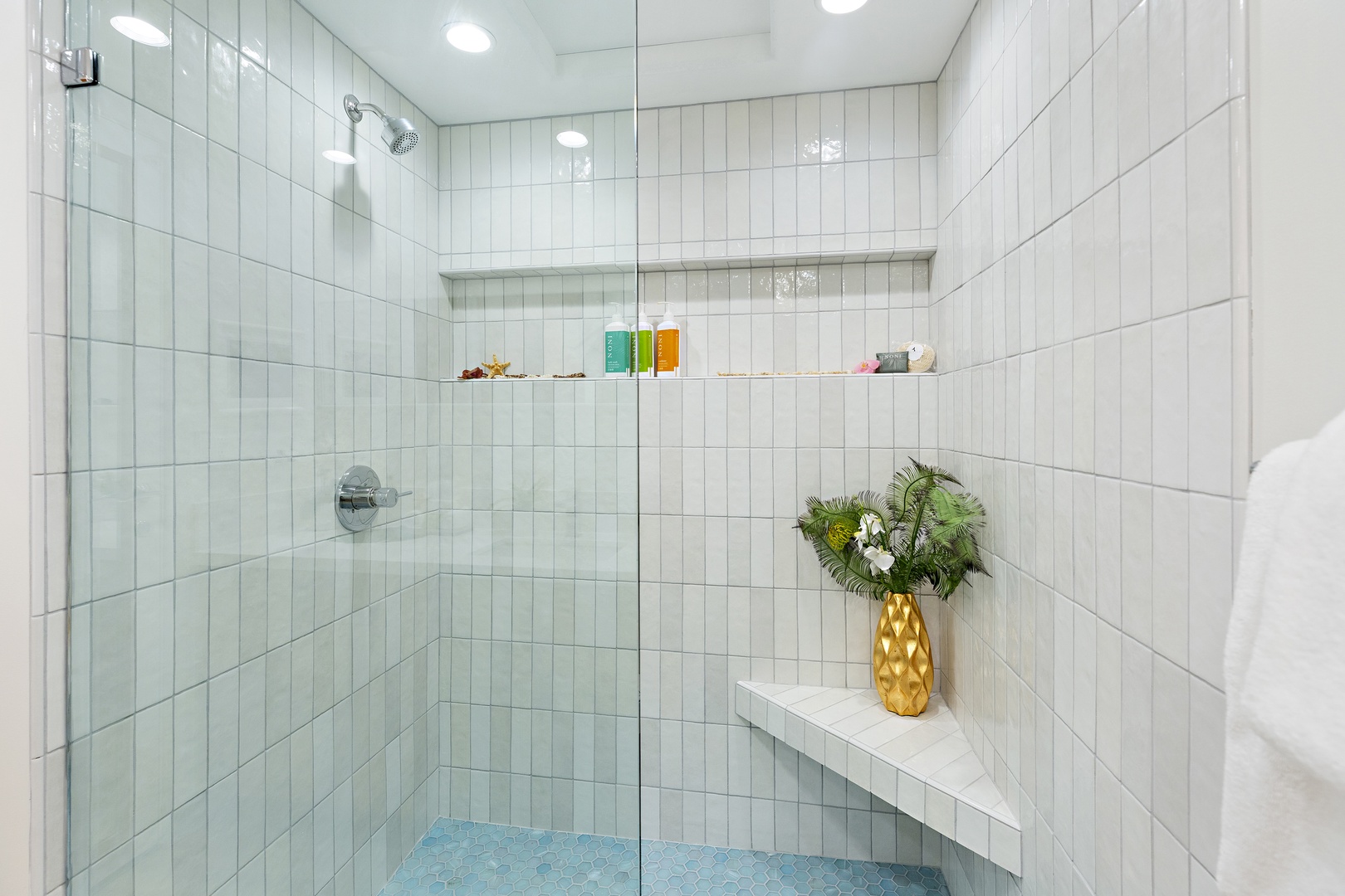 Step into your private spa-like retreat with a spacious walk-in shower featuring sleek glass doors, built-in storage niches, and thoughtful design touches that make freshening up a pleasure.