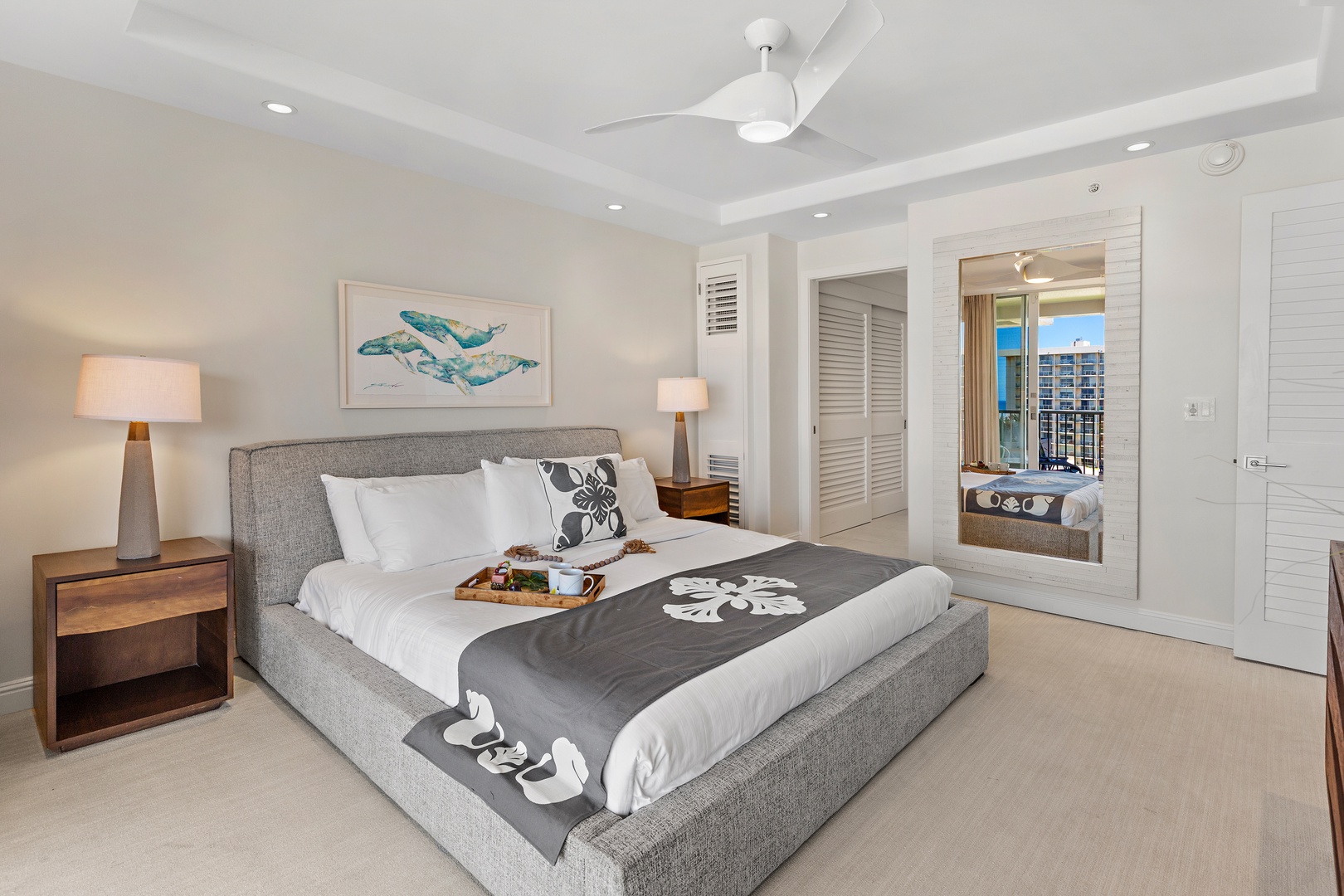 Slip into crisp linens and let the ceiling fan's gentle breeze lull you to sleep. Your private balcony with city views awaits just beyond those elegant shutters.