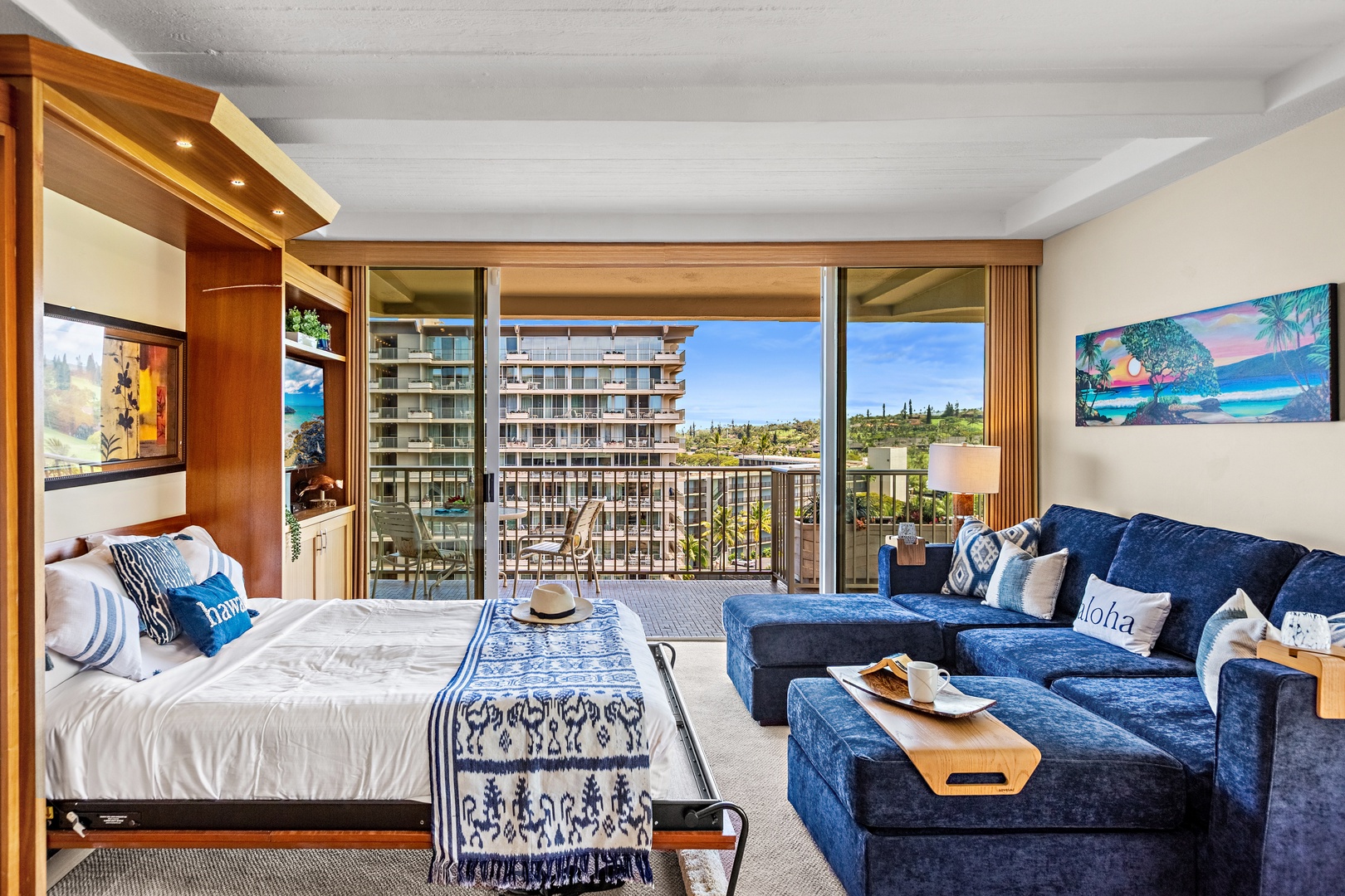 Unwind in your spacious studio with a Murphy bed and plush navy sofa while enjoying the views from your private balcony.