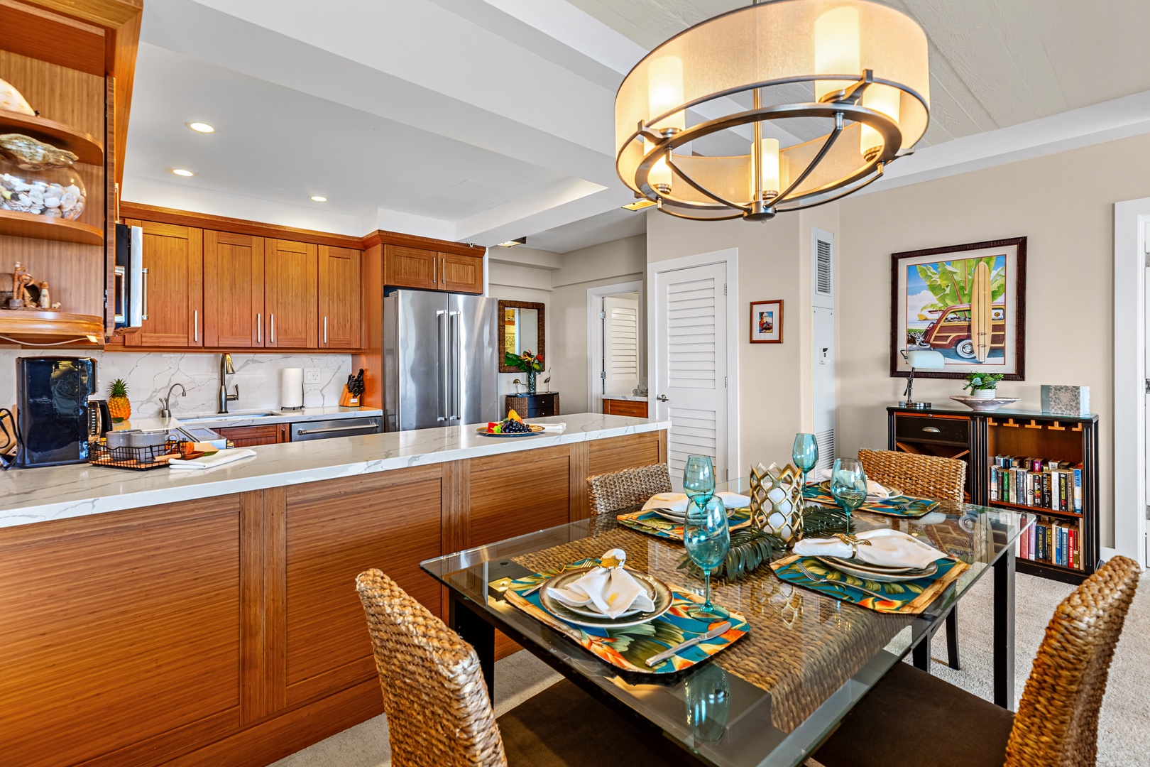 Your open-concept kitchen and dining space features warm wood cabinetry, modern appliances, and stylish tropical décor for memorable meal prep.