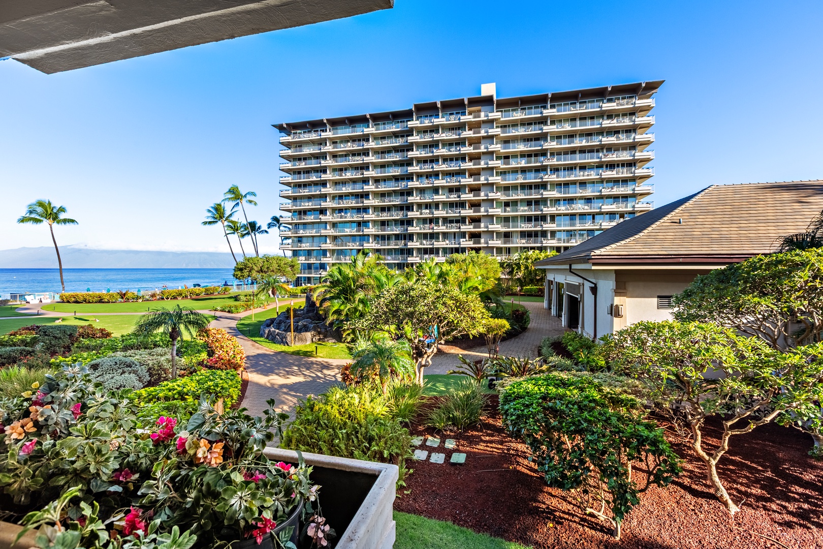 Unwind in comfortable outdoor seating as the island’s lush peaks and golden skies create the perfect peaceful escape.