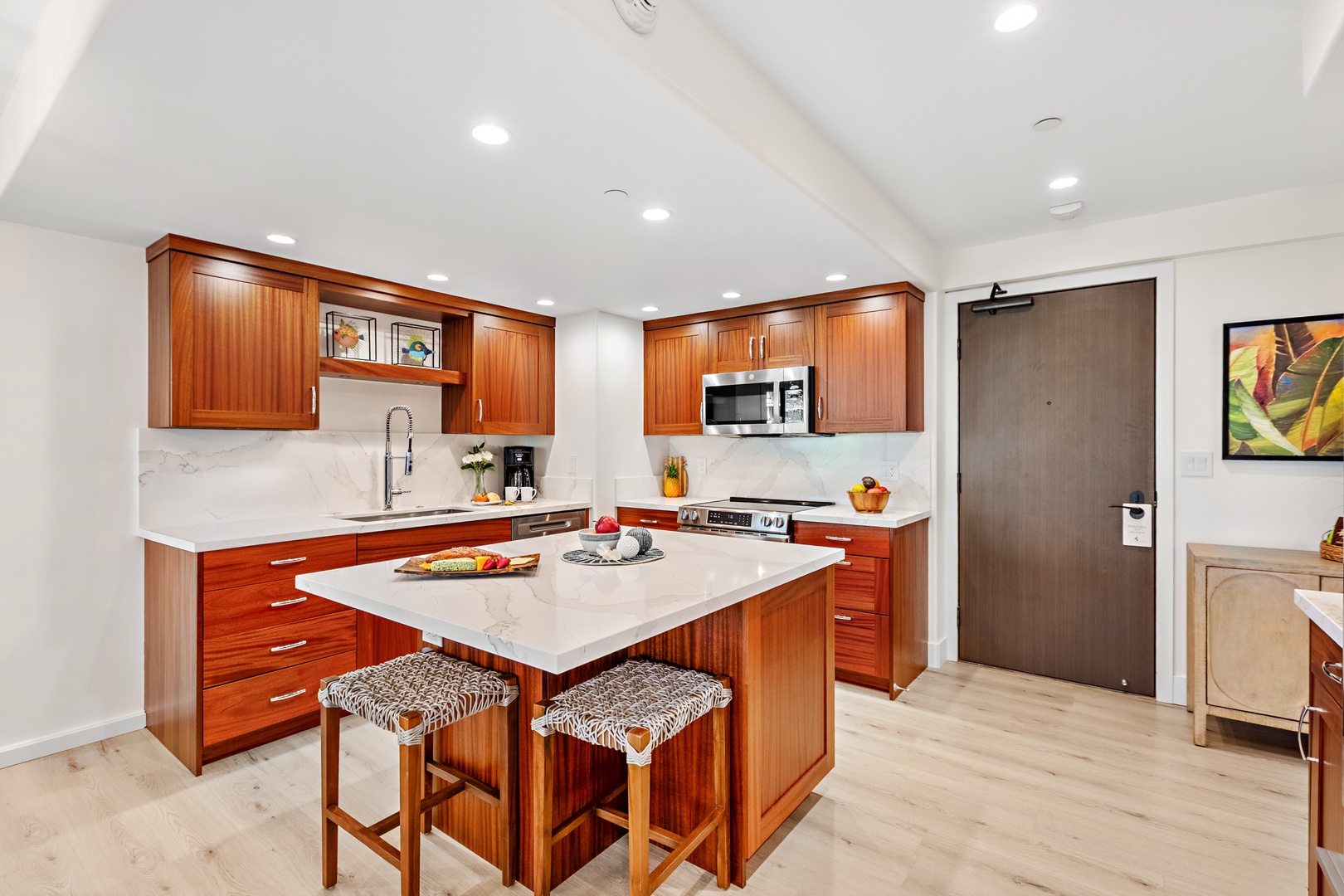 Your gourmet kitchen awaits with rich wood cabinetry, counters, and stainless-steel appliances. Perfect for preparing memorable meals together.