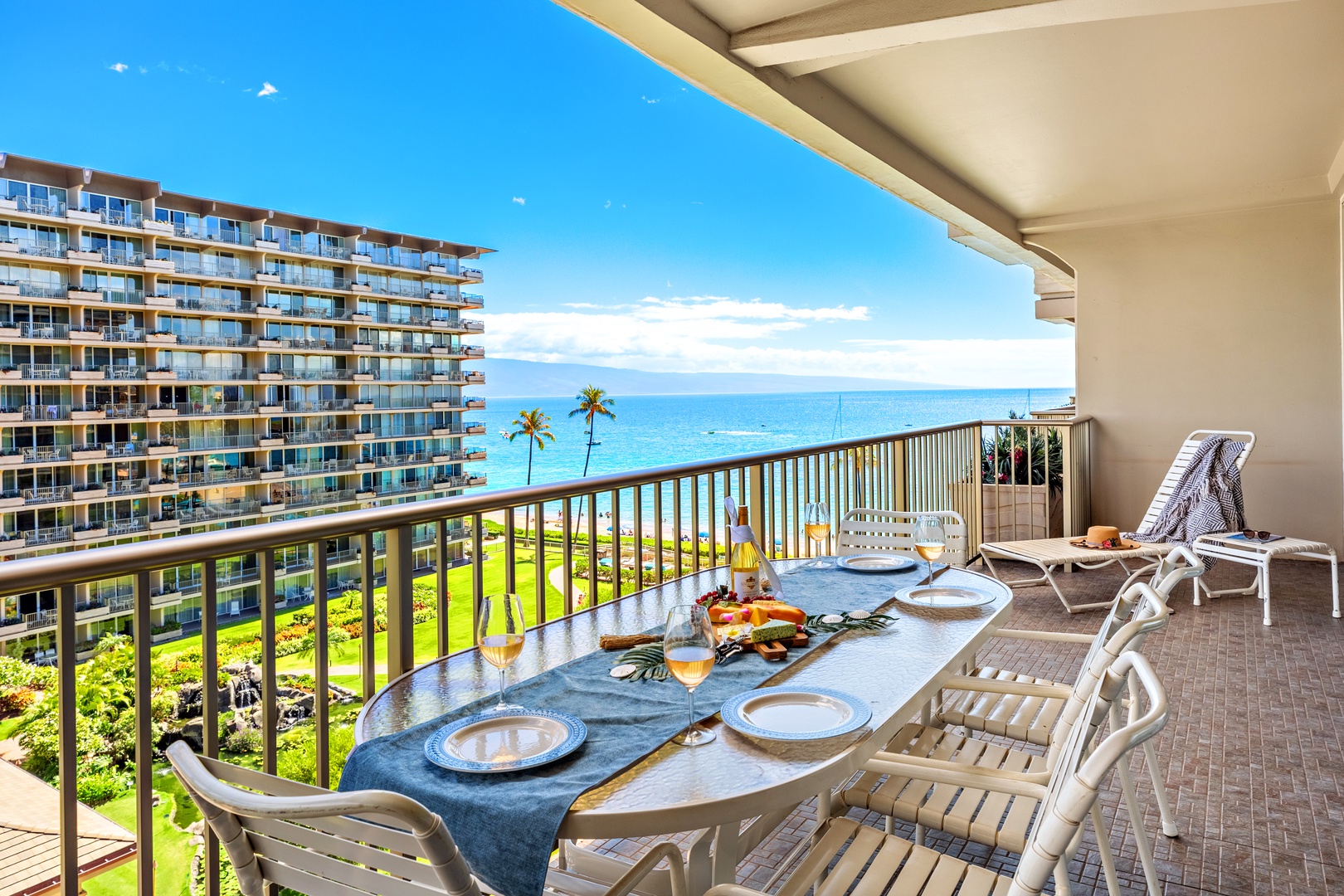 Picture yourself savoring breakfast on your private balcony, where azure ocean waters stretch to the horizon and tropical breezes sweep across swaying palms below. The spacious terrace invites you to unwind on lounge chairs after a day at the beach.